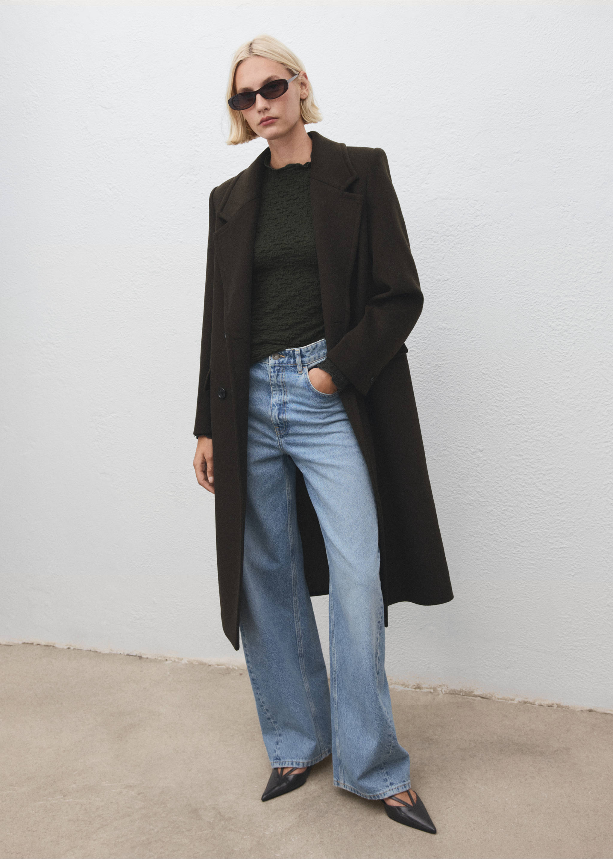 Dark green textured top with ruffled high neck, worn with a long coat and blue jeans., Khaki. Ref: 17057793-00.