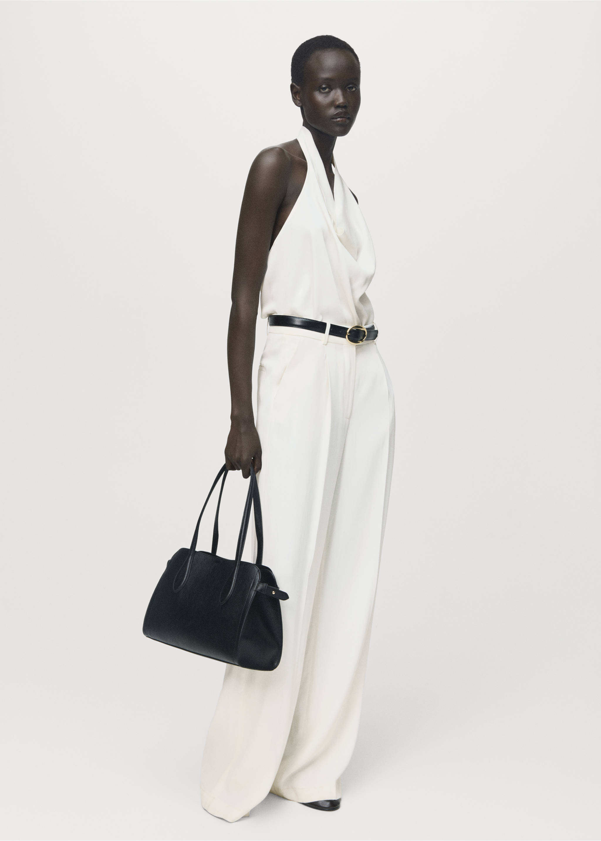 White sleeveless halter-neck blouse with a draped cowl neckline, worn with wide-leg trousers., Ecru. Ref: 17057803-00.