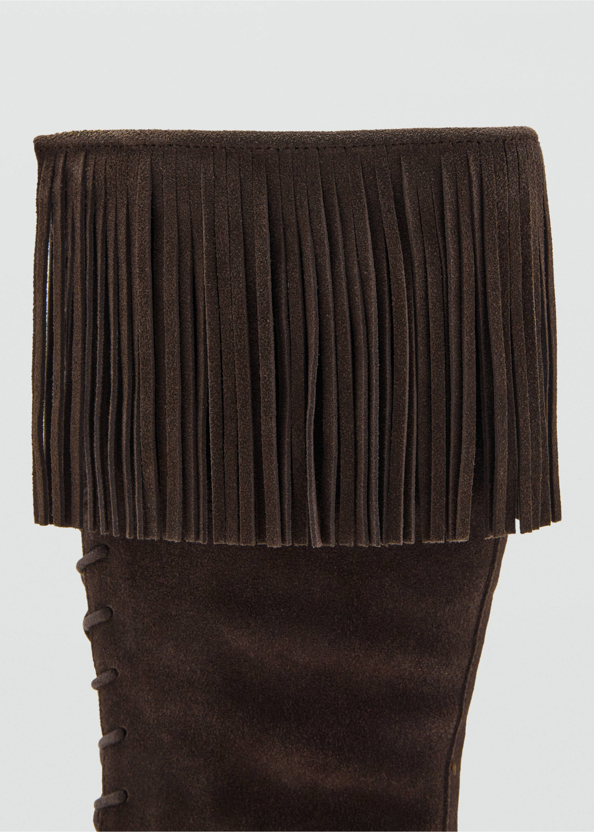 Dark brown suede boot detail featuring a fringe cuff and side lacing., Chocolate. Ref: 17057894-00.