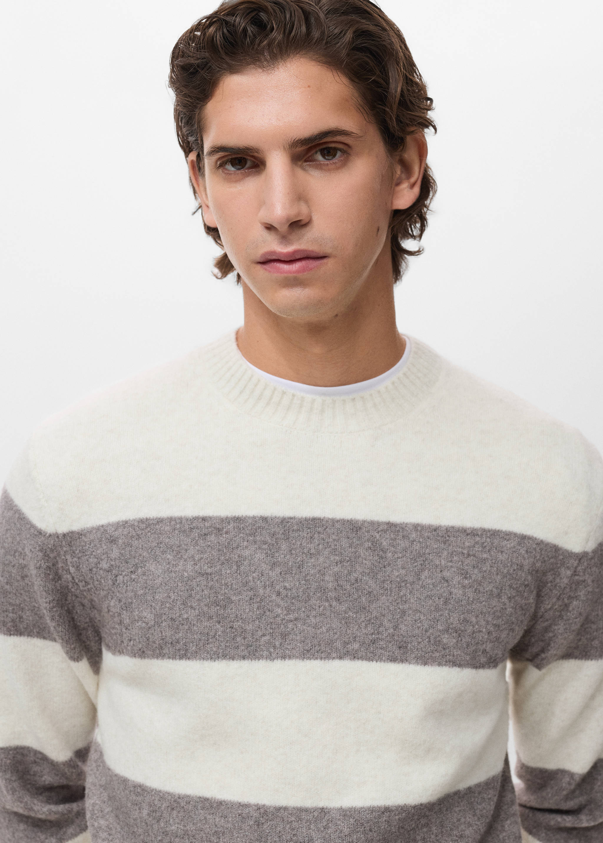Off-white and grey striped knitted jersey with a ribbed crew neck.