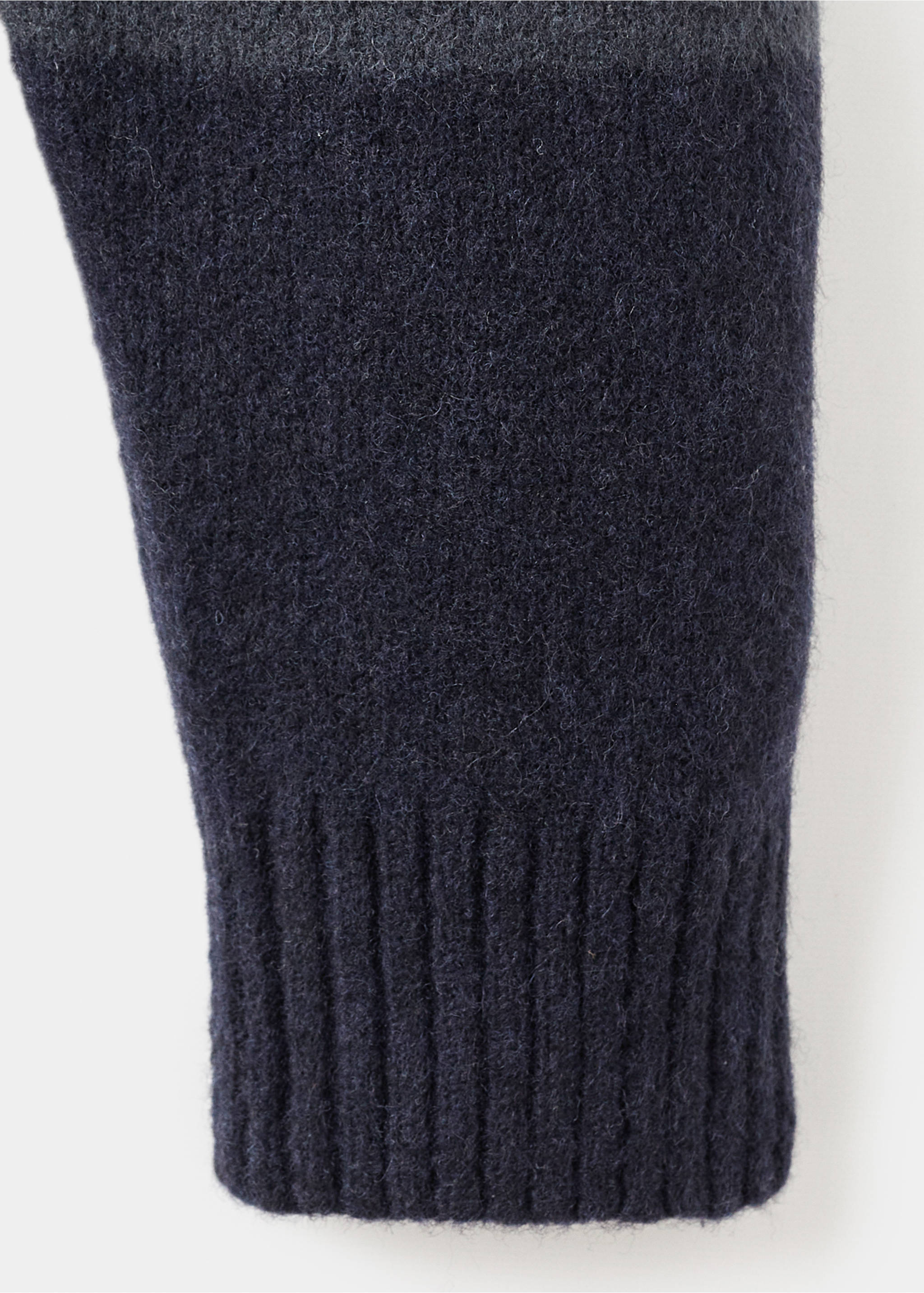 Navy blue knitted jersey sleeve and ribbed cuff close-up., Indigo Blue. Ref: 17057896-00.
