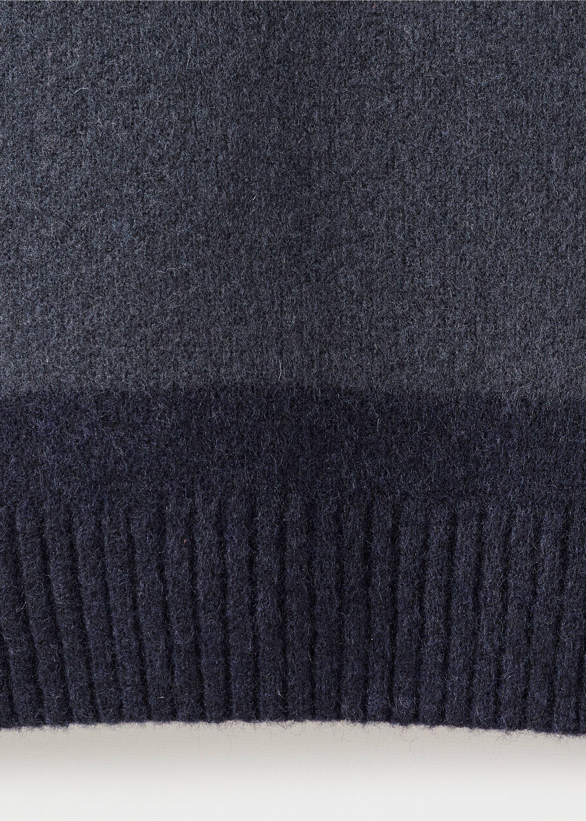 Close-up of a dark grey men's jersey showing the soft knit texture and ribbed hem., Indigo Blue. Ref: 17057896-00.