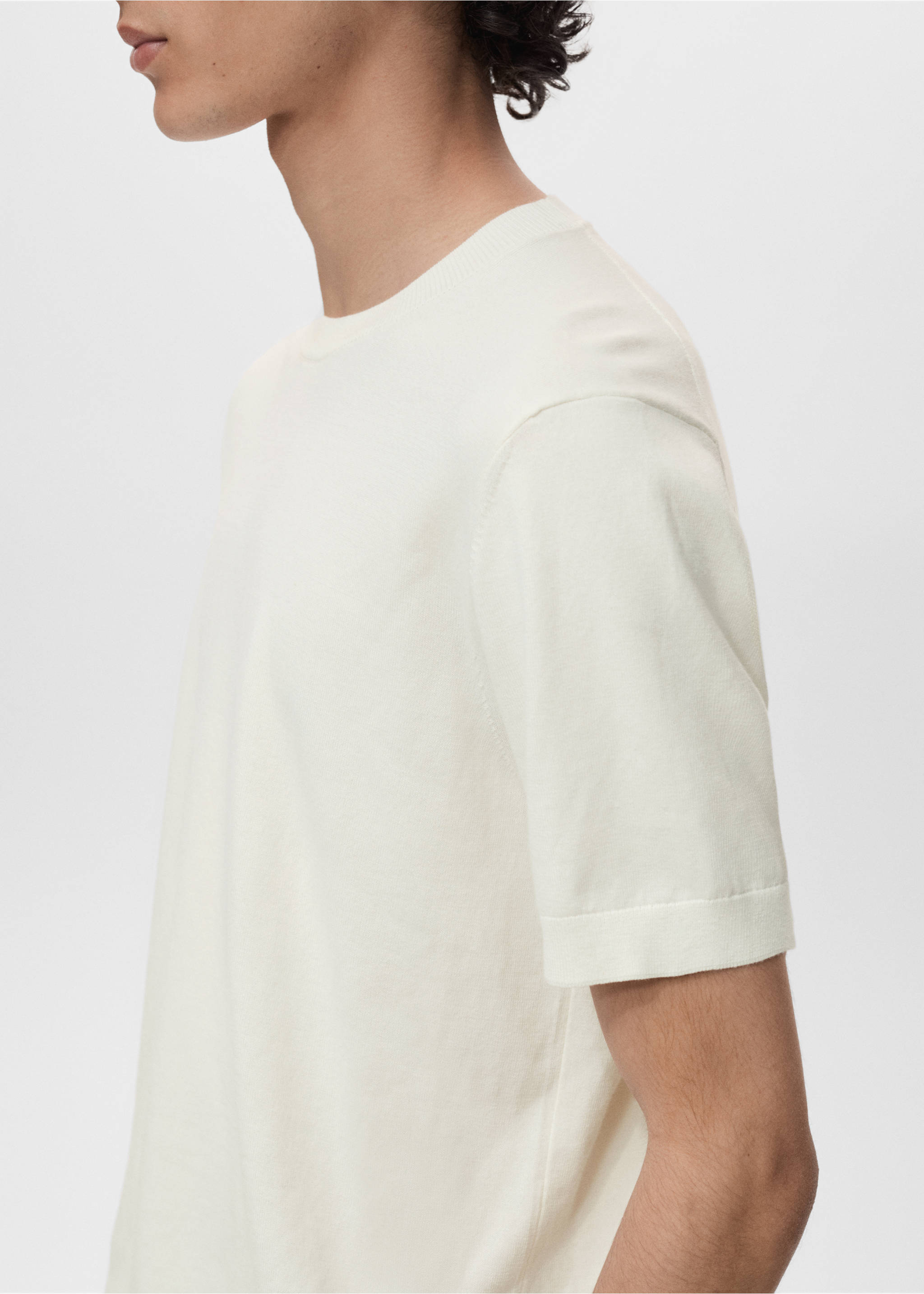 Off-white short-sleeved knit t-shirt with a rounded ribbed neckline, shown in a close-up., Off White. Ref: 17061245-00.