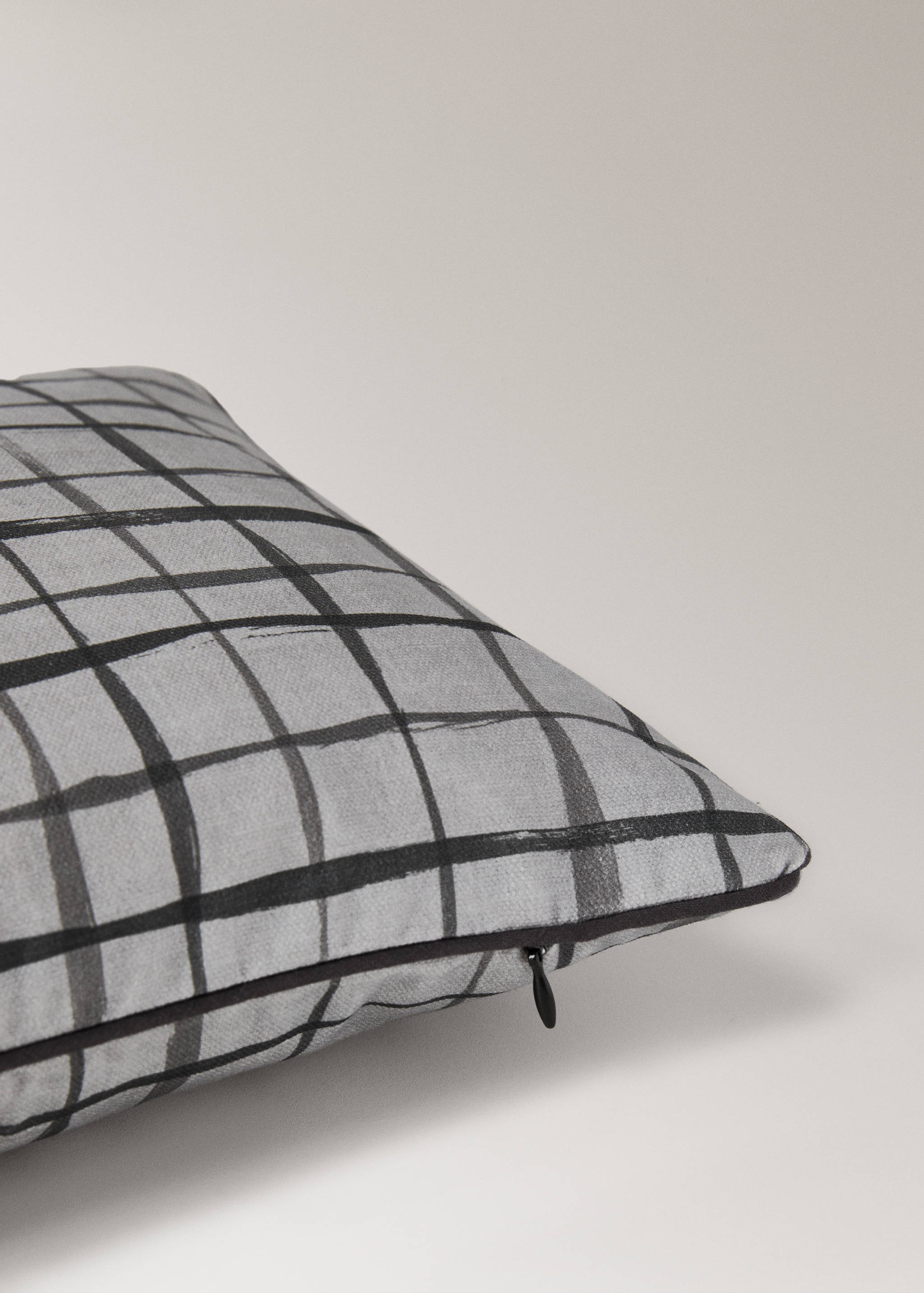 Grey cushion cover with a black painted check pattern and side zip.