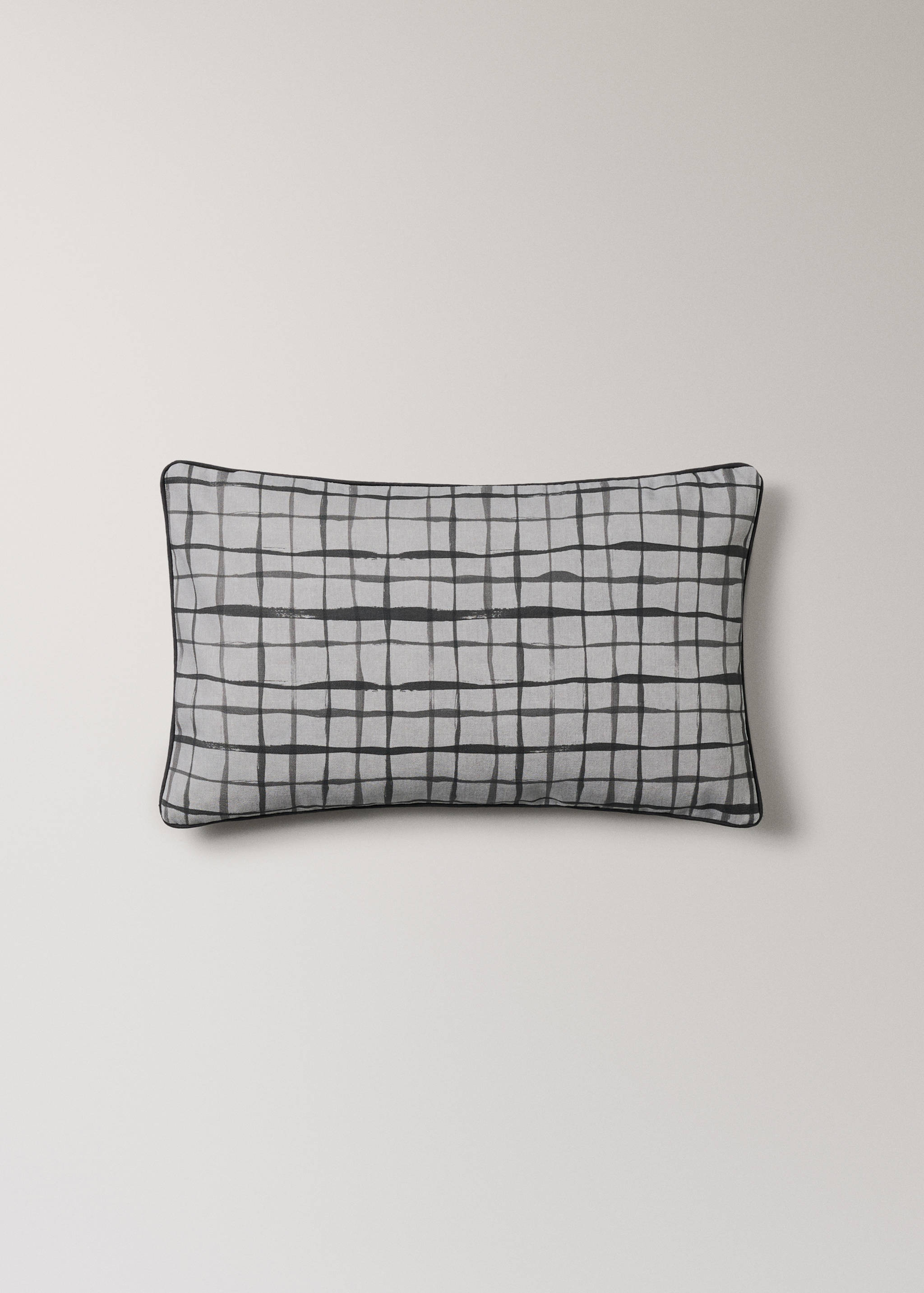 Grey and black checked cushion cover with dark piping.