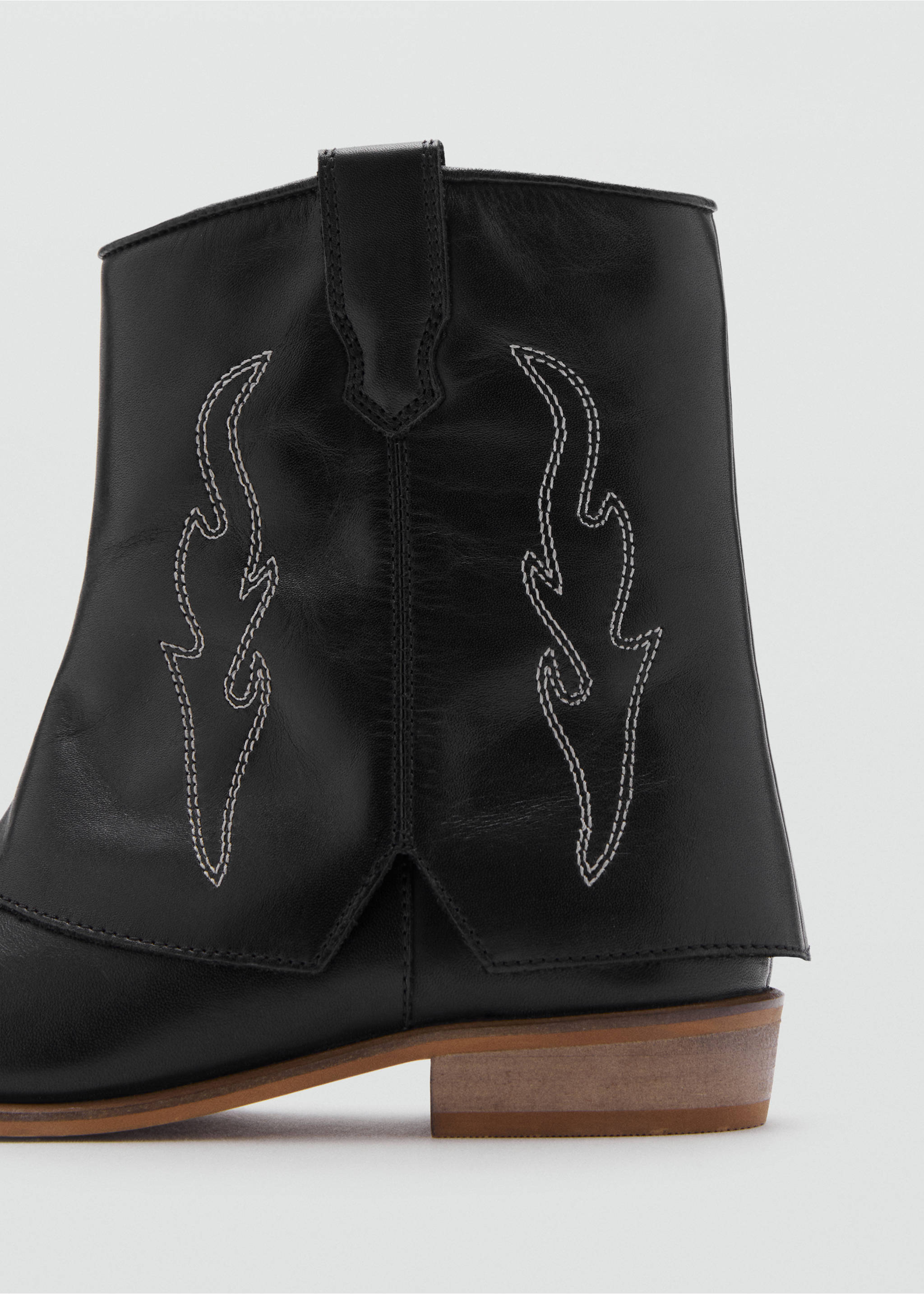 Close-up of a black leather boot with contrast white stitching., Black. Ref: 17066328-00.