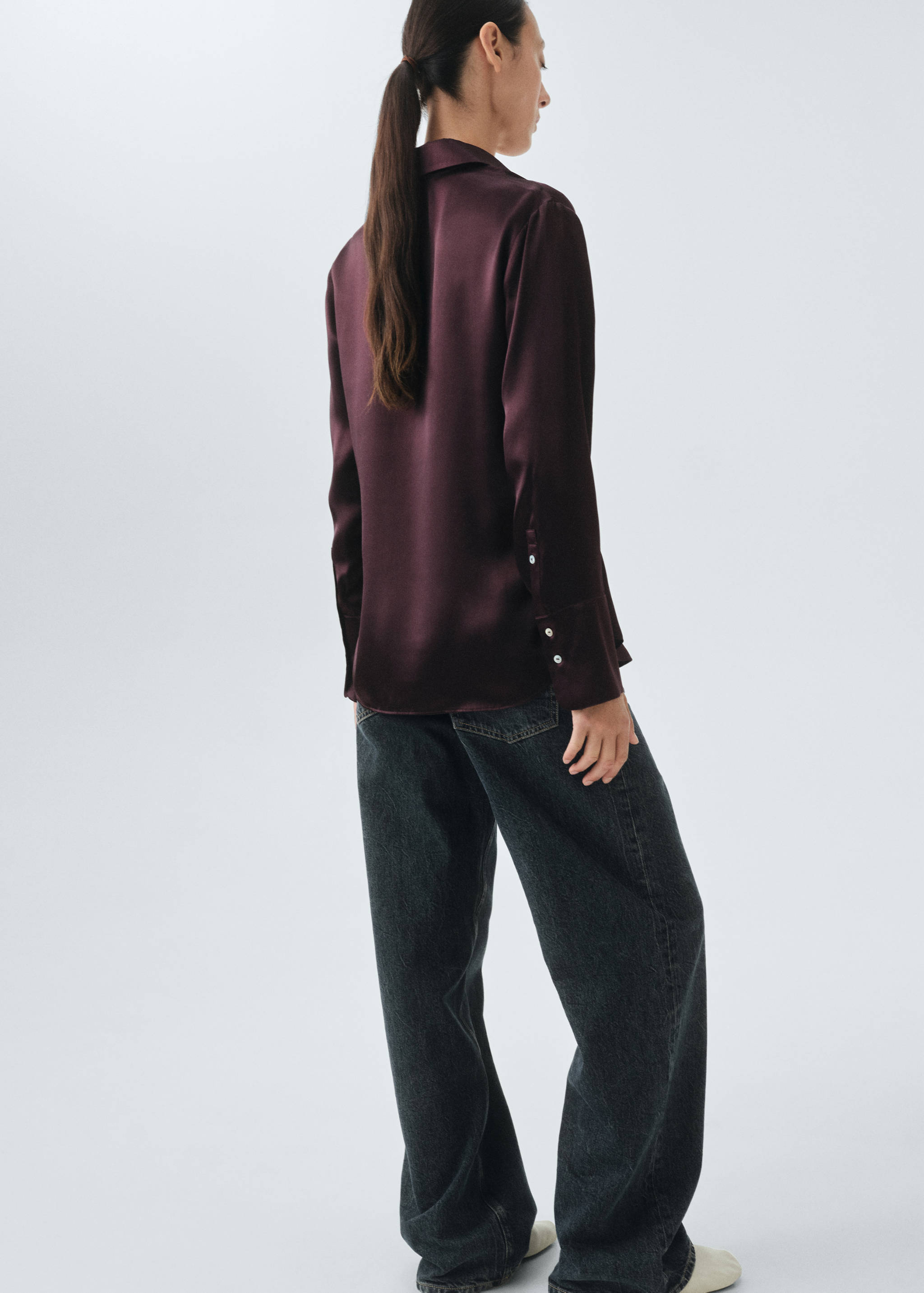 Burgundy satin shirt from the back, featuring a collar and long sleeves with buttoned cuffs.