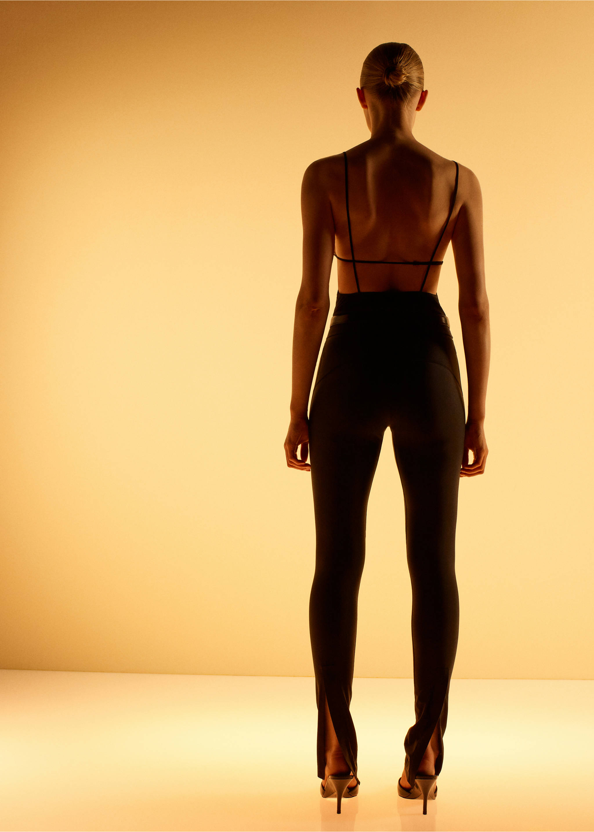 Black leggings shown from the back, featuring a high waist and split hems., Black. Ref: 17066356-00.