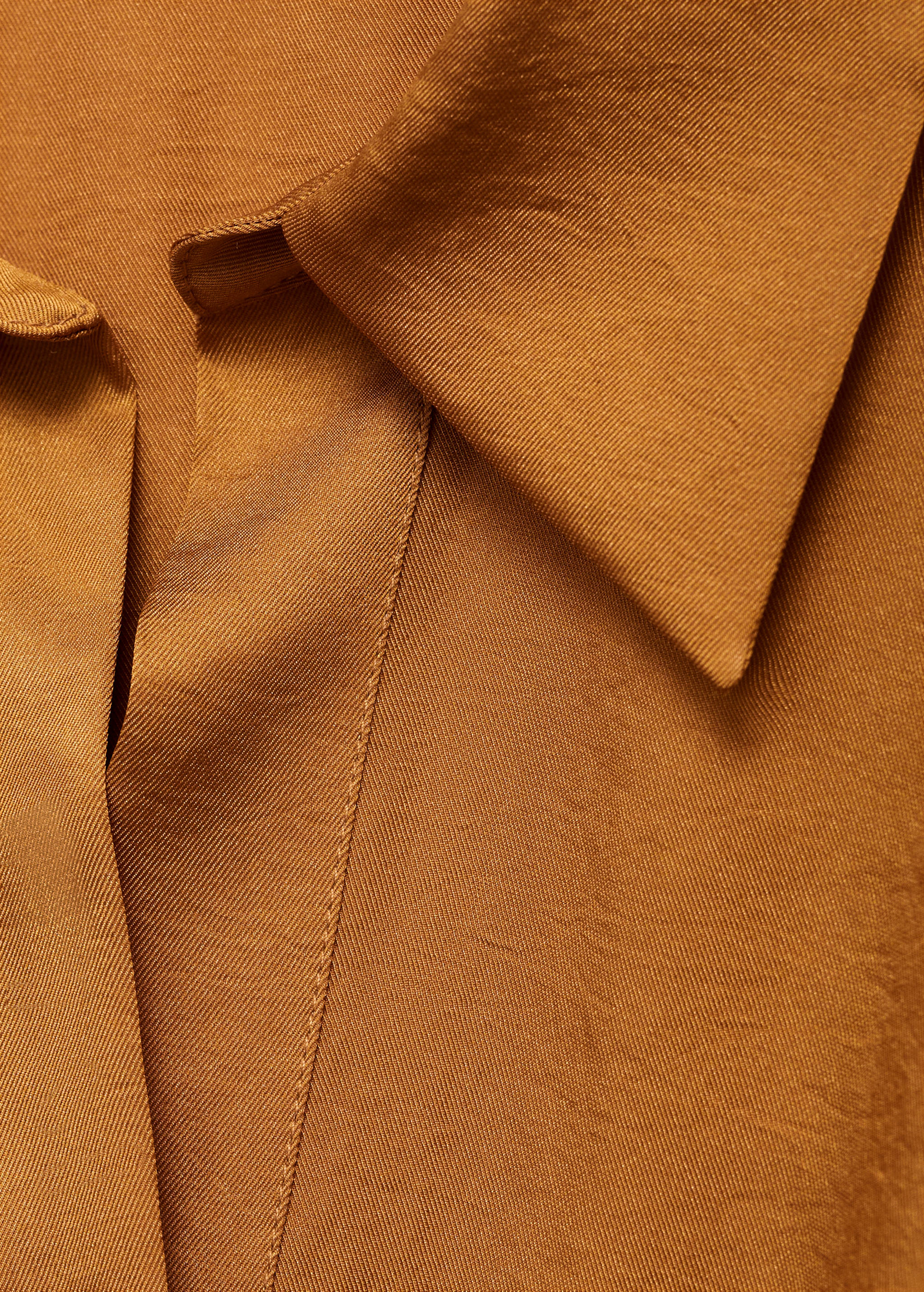 Brown shirt collar and placket detail.