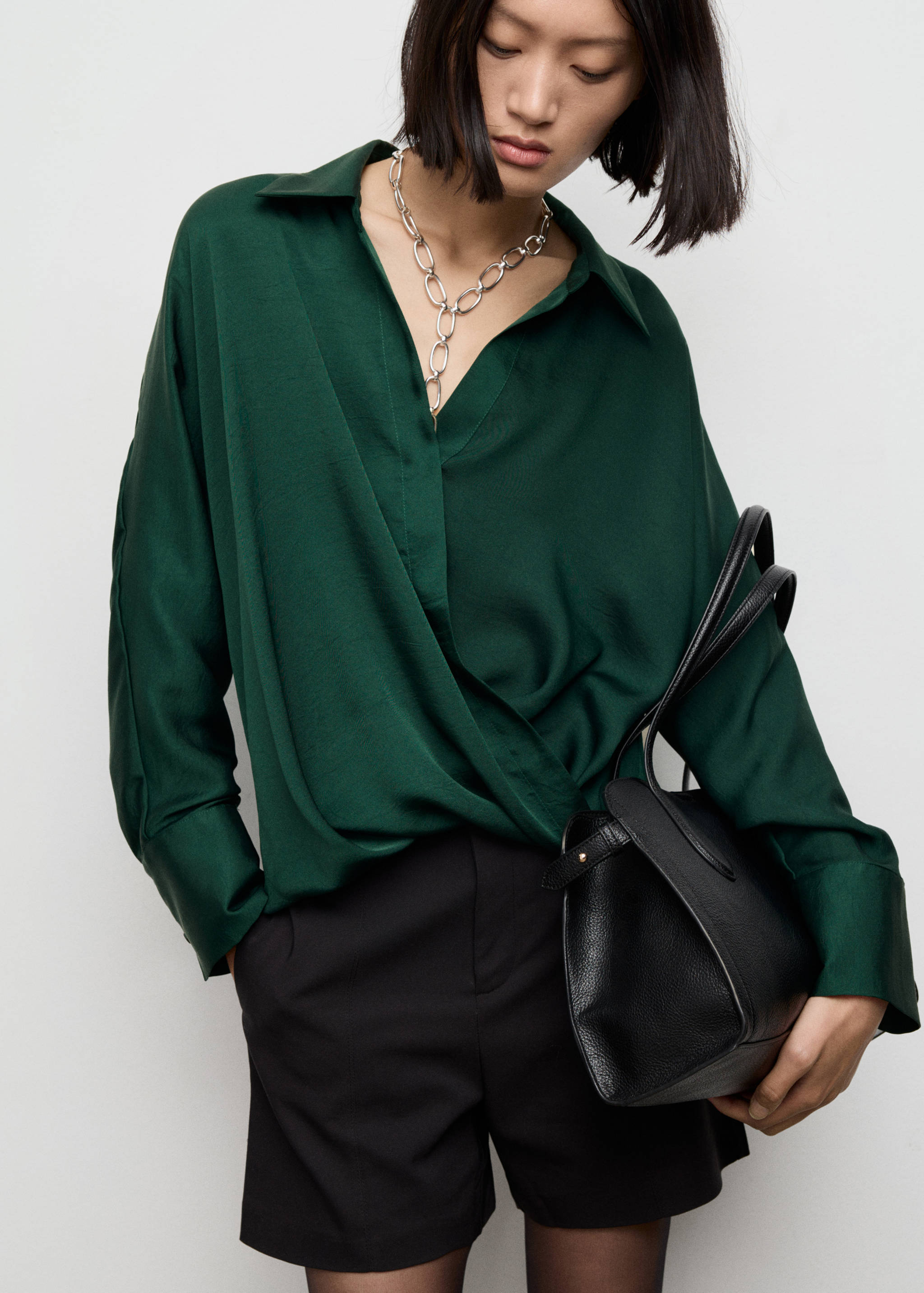 Dark green wrap-front shirt with long sleeves and a collar.