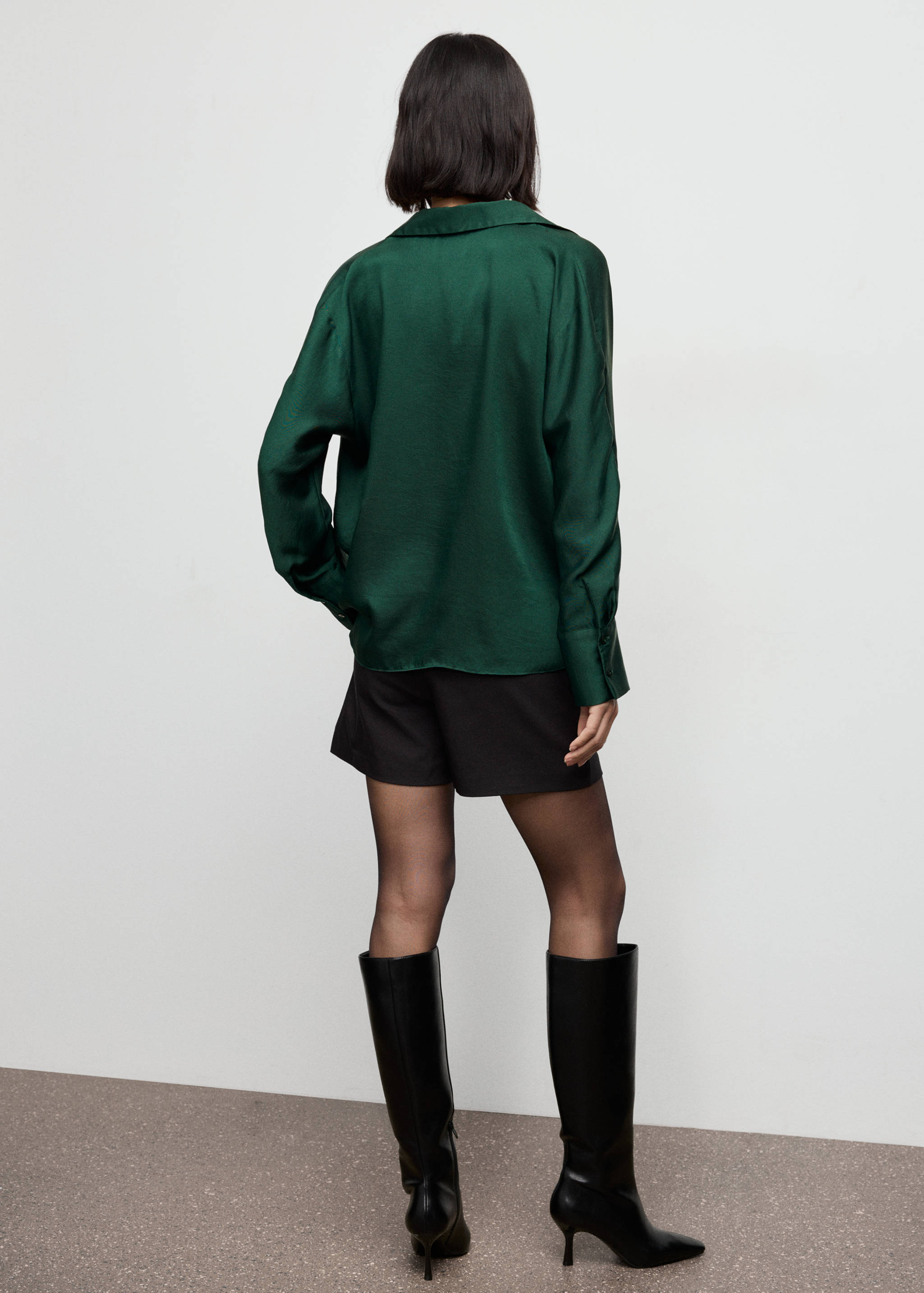 Dark green long-sleeve shirt shown from the back, paired with black shorts.