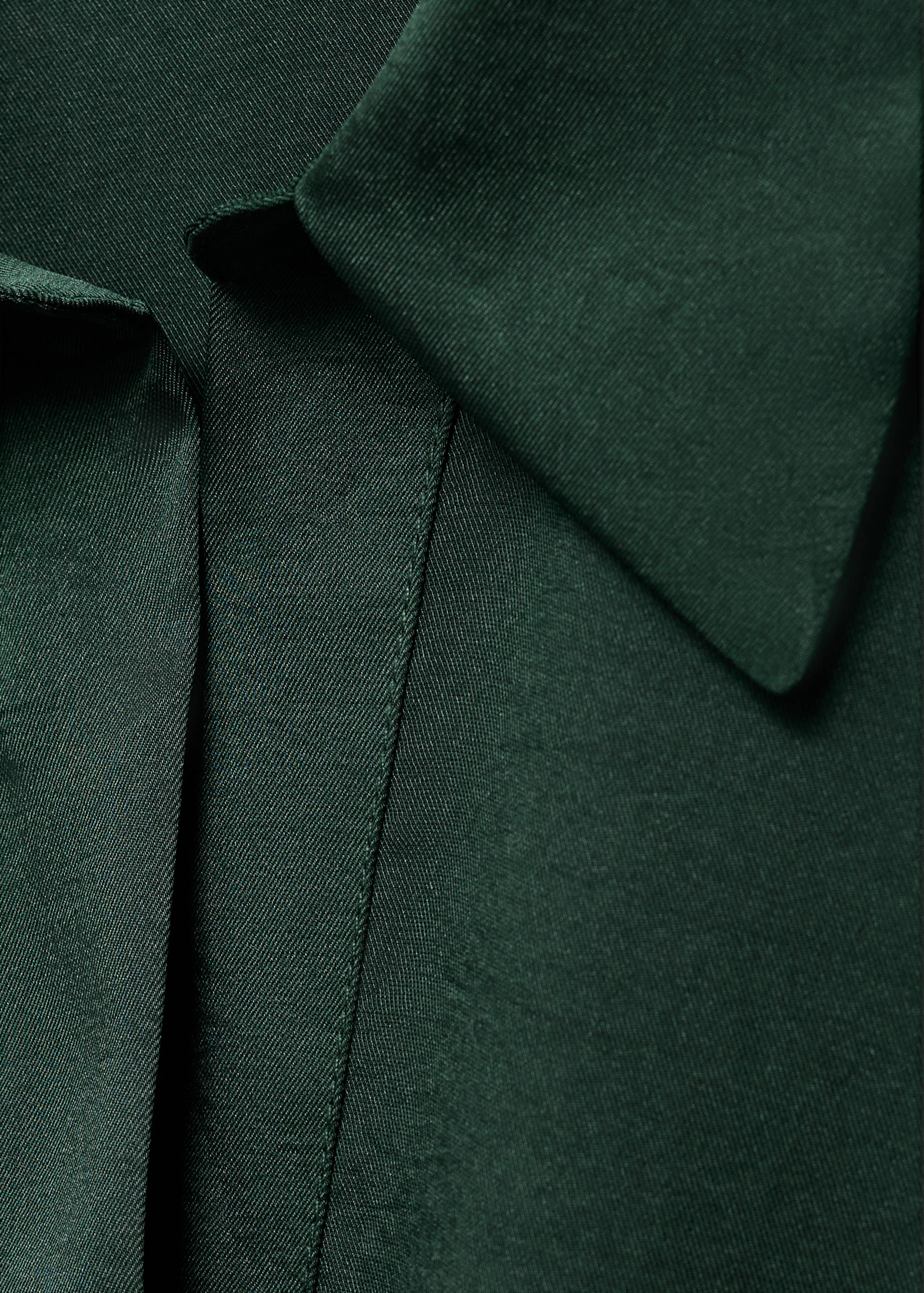Dark green shirt collar and placket detail.