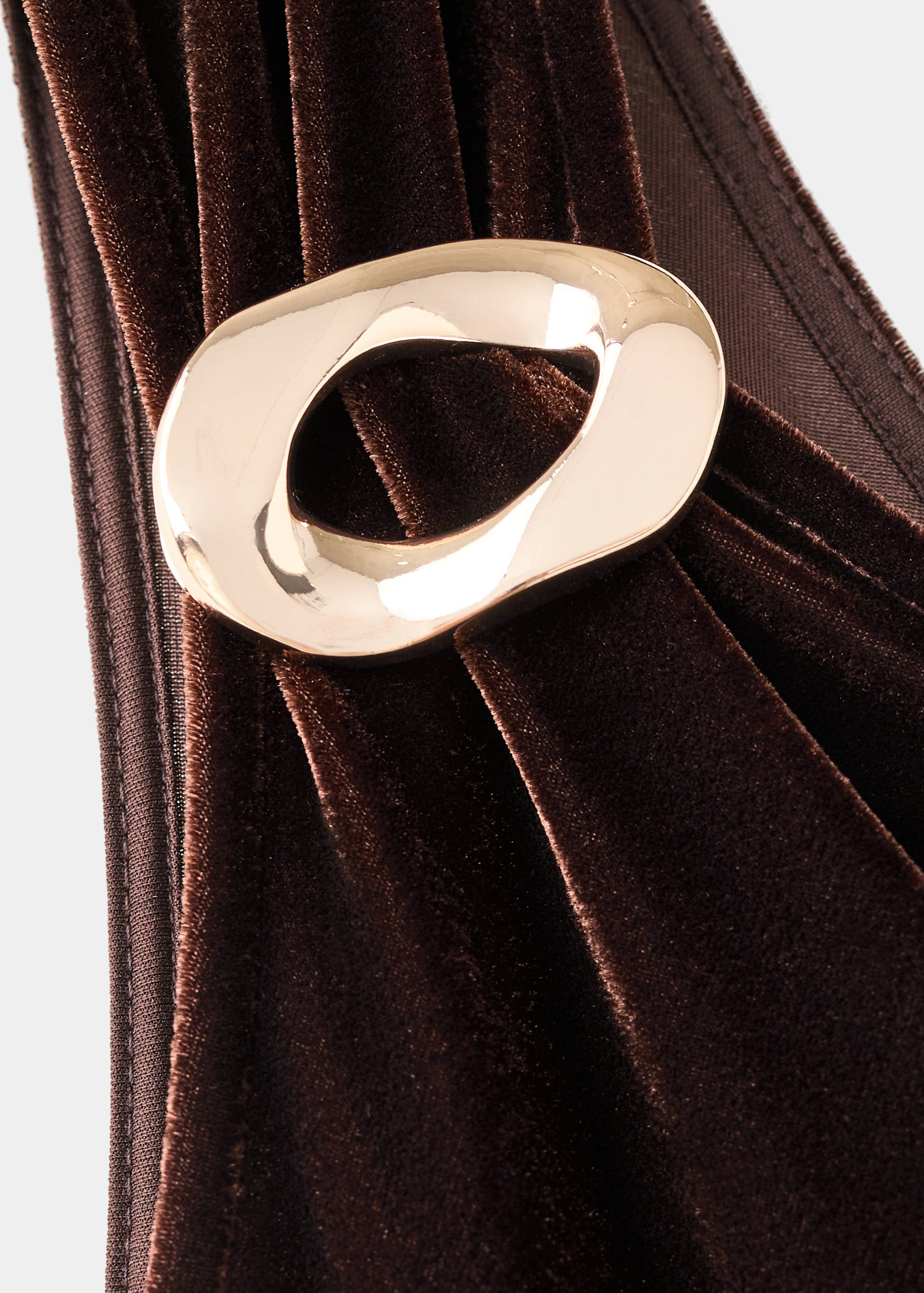 Brown velvet jumpsuit detail with a gold buckle