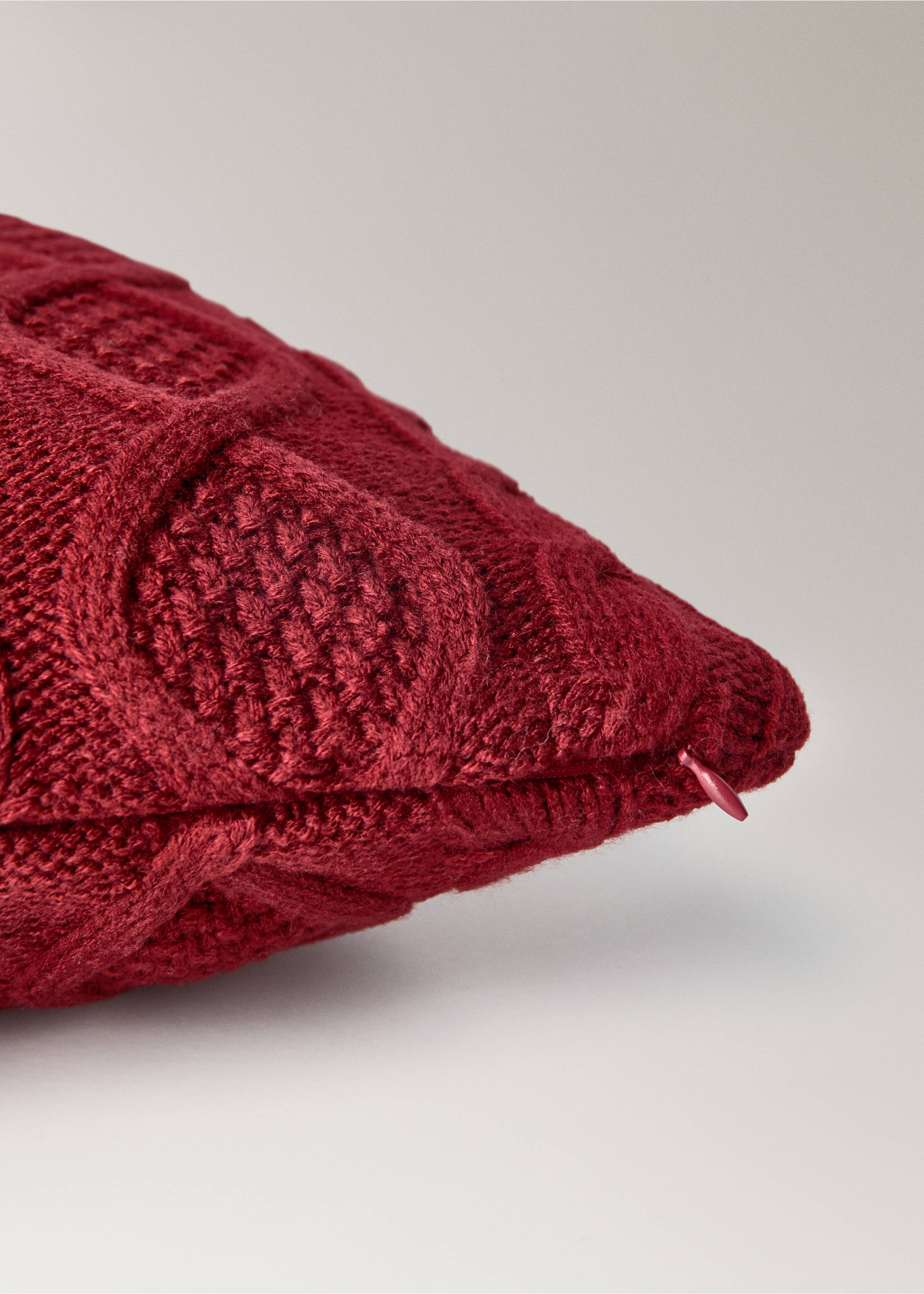 Dark red knitted cushion cover close-up showing texture and zip., Red. Ref: 17067902-00.