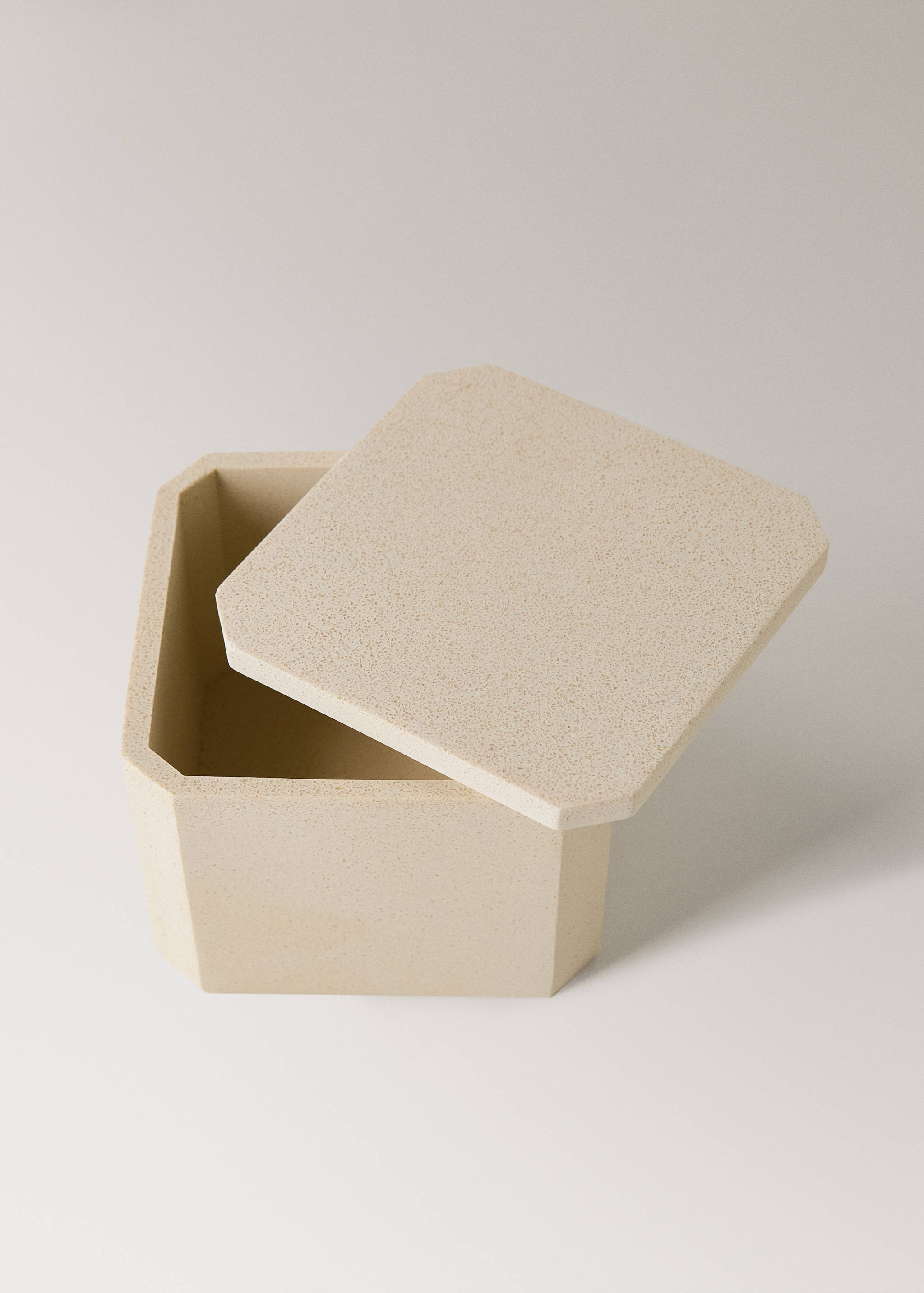 Beige speckled octagonal decorative box with a matching lid.