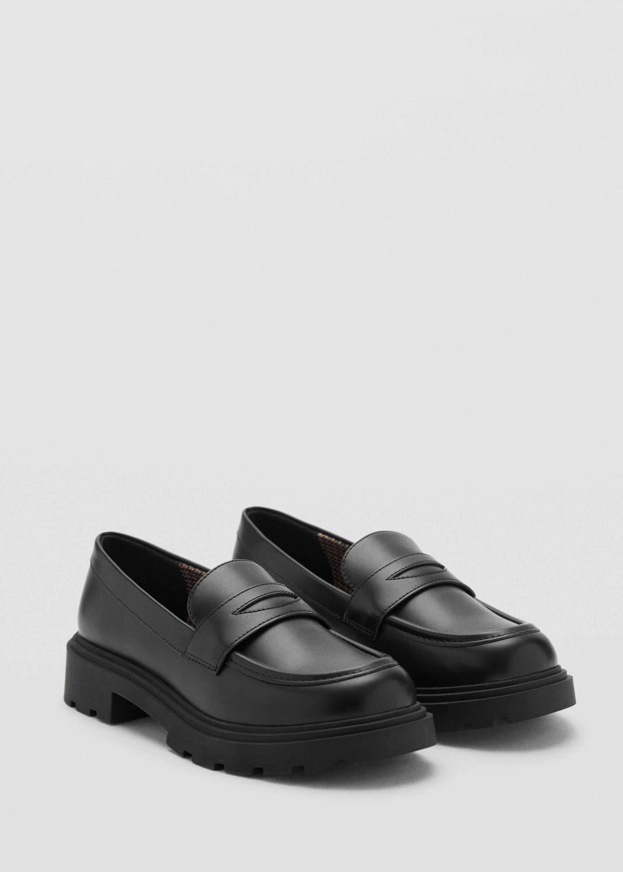 Black children's loafers with penny straps and chunky ridged soles.