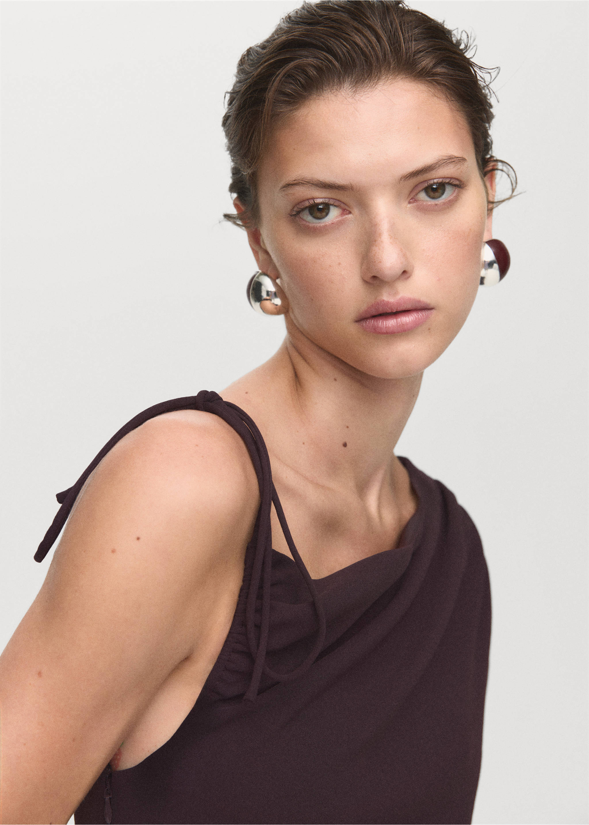 Jumpsuit with asymmetrical neck and bow - Details of the article 1, Brown. Ref: 17074145-00.