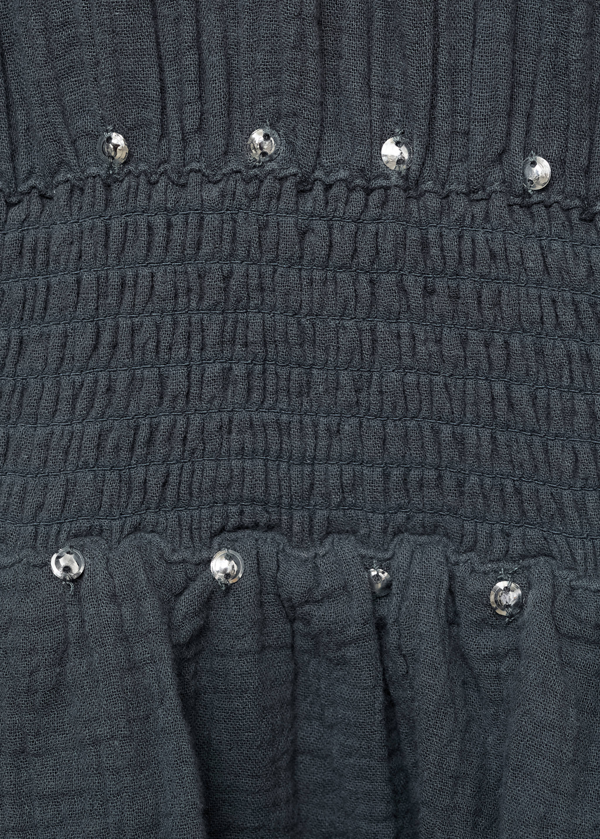 Dark grey dress with a smocked waistband and metallic studs.