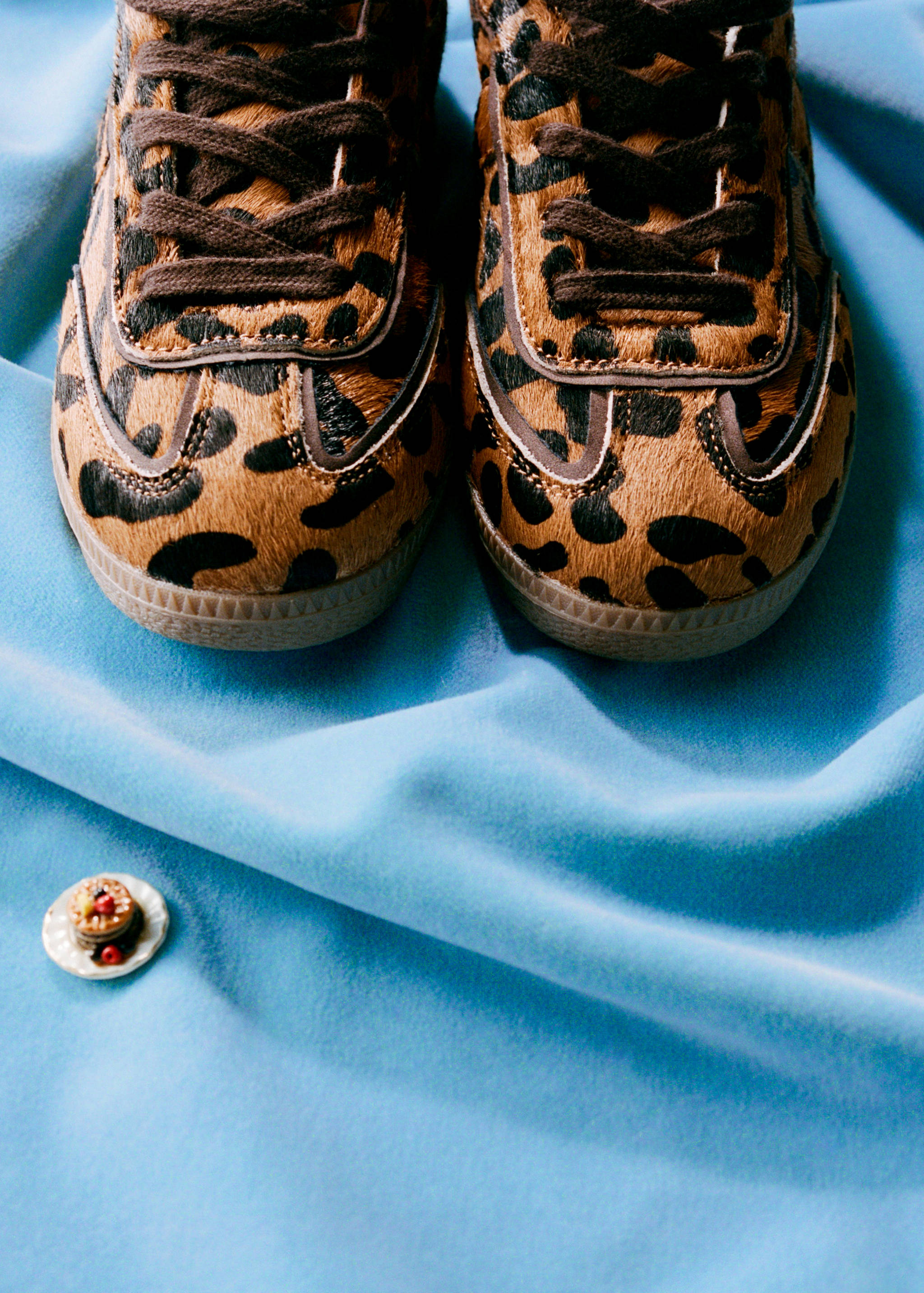 Kids' brown and black leopard-print faux-fur trainers with brown laces.
