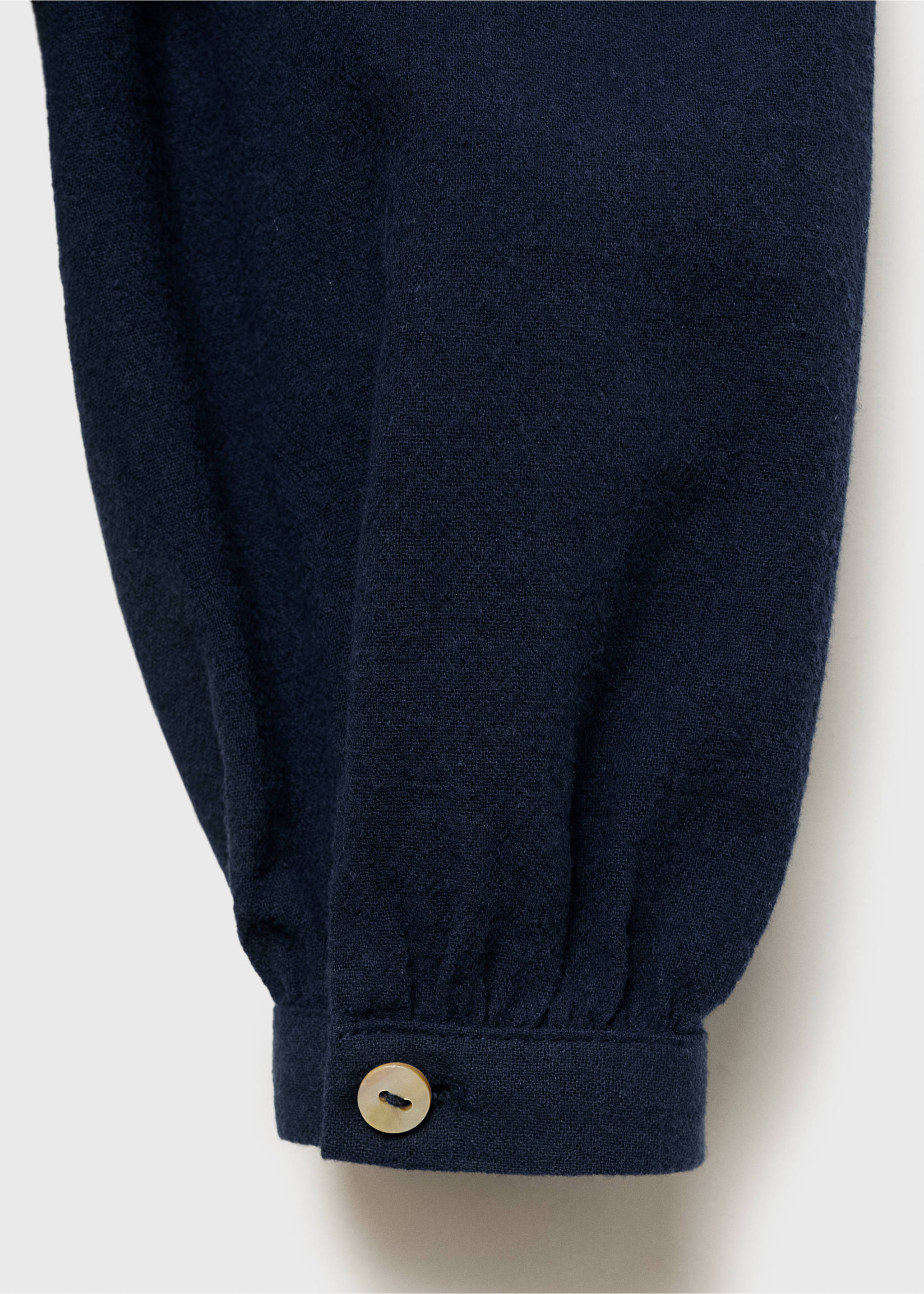 Close-up of a navy blue blouse sleeve with a buttoned cuff., Navy. Ref: 17075156-00.