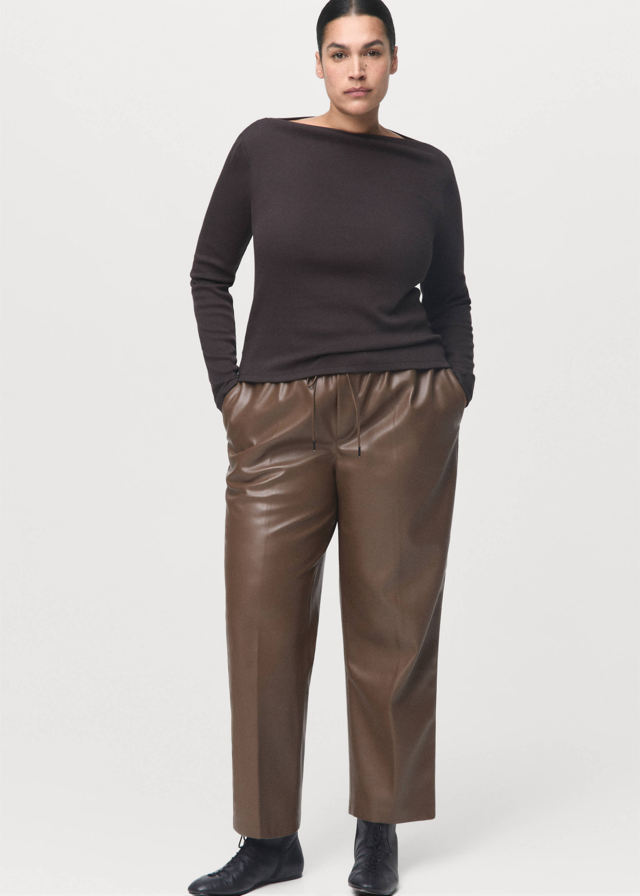 Brown faux-leather trousers with an elasticated drawstring waist and a relaxed fit.