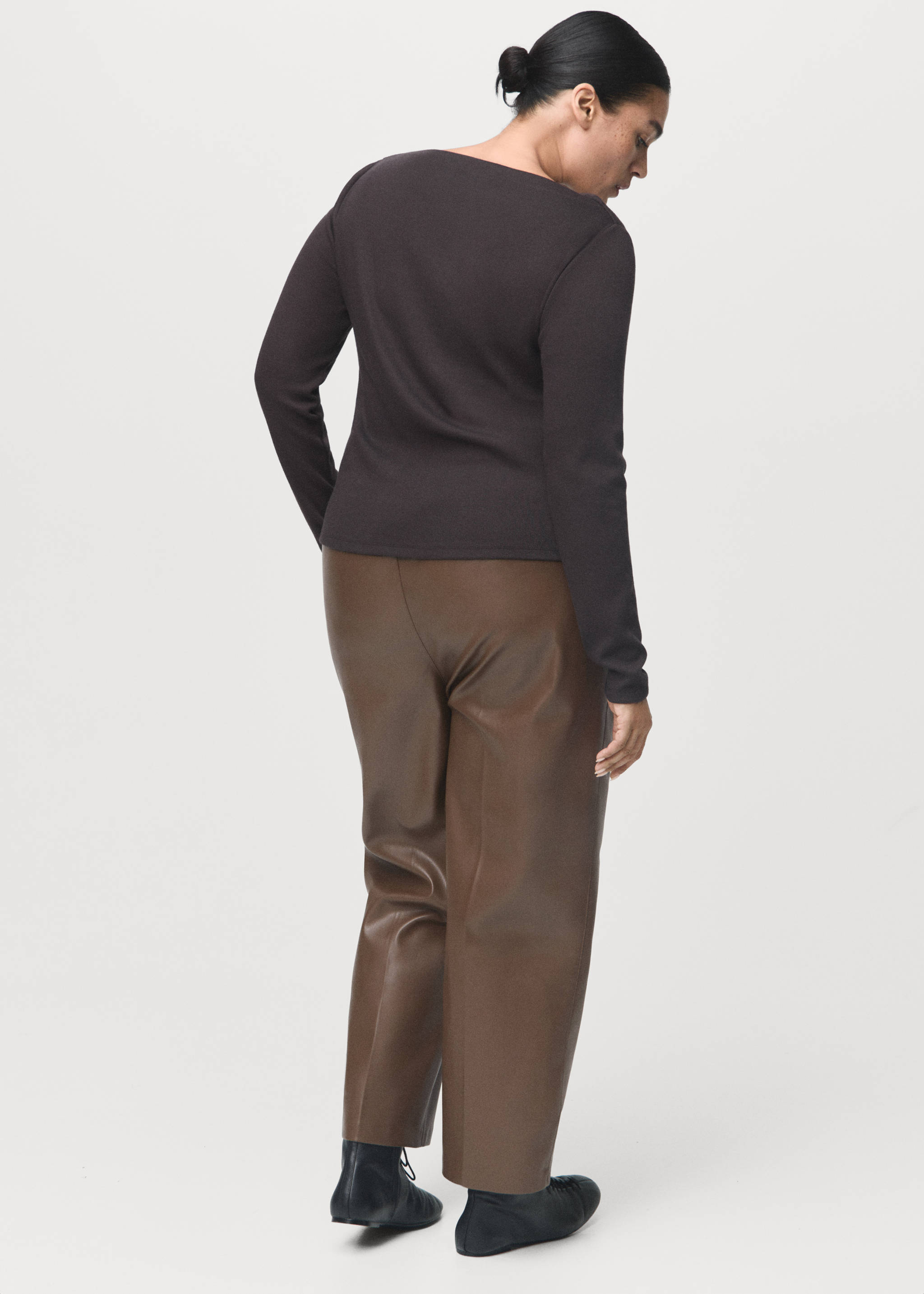 Brown faux-leather trousers worn by a plus-size model, back view.
