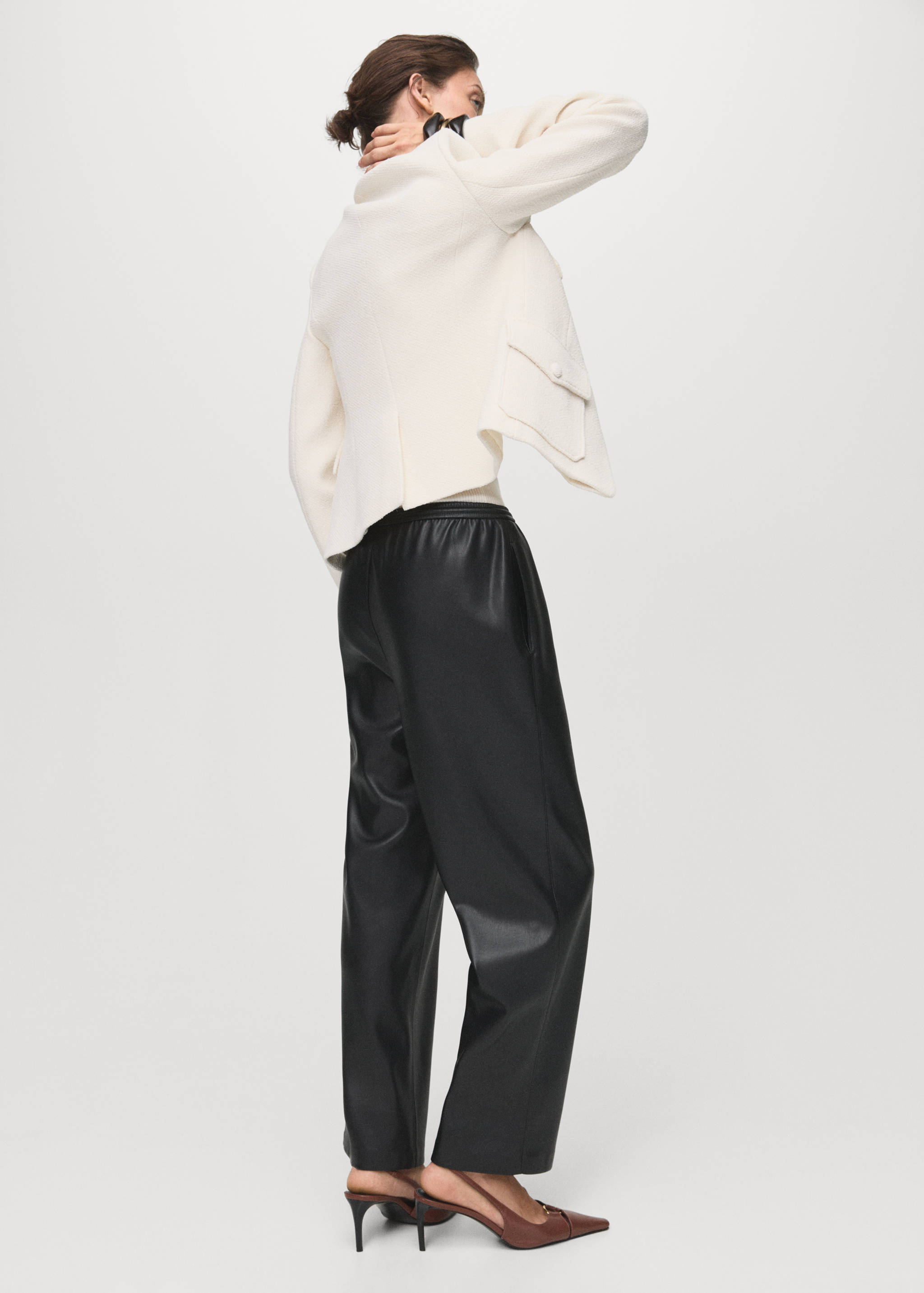 Black trousers with an elasticated waistband, seen from the back.