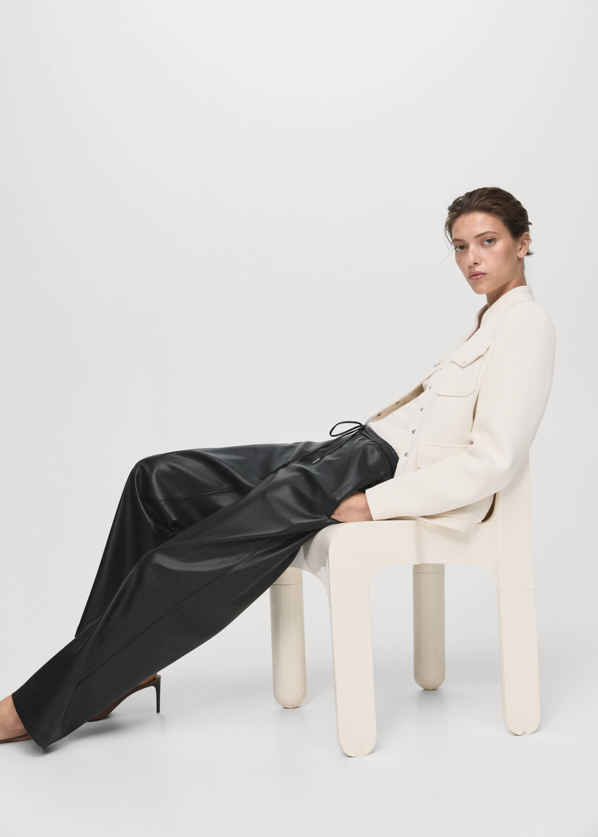 Relaxed-fit black faux-leather trousers with a drawstring waist.