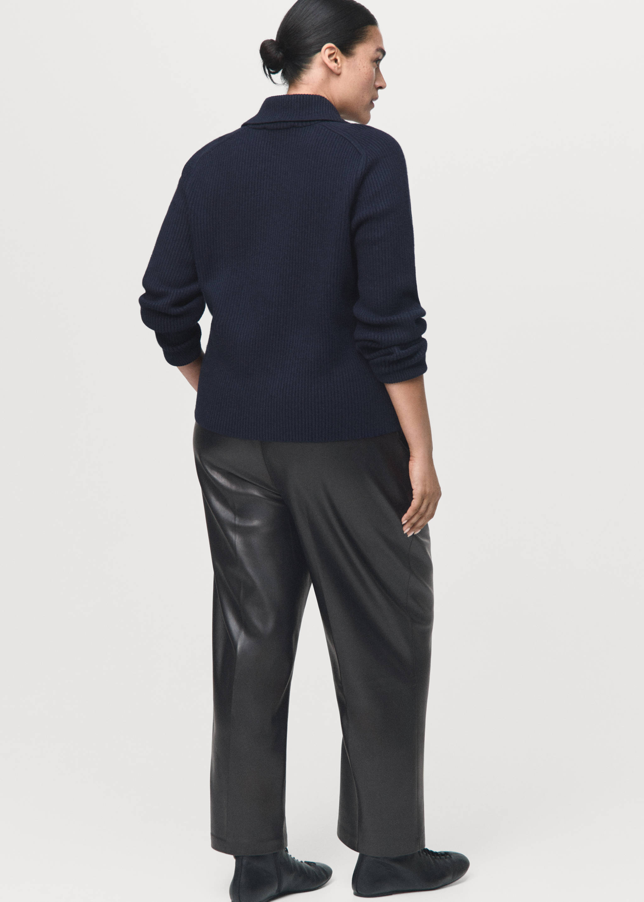Black faux-leather trousers with a straight-leg cut, shown from the back.