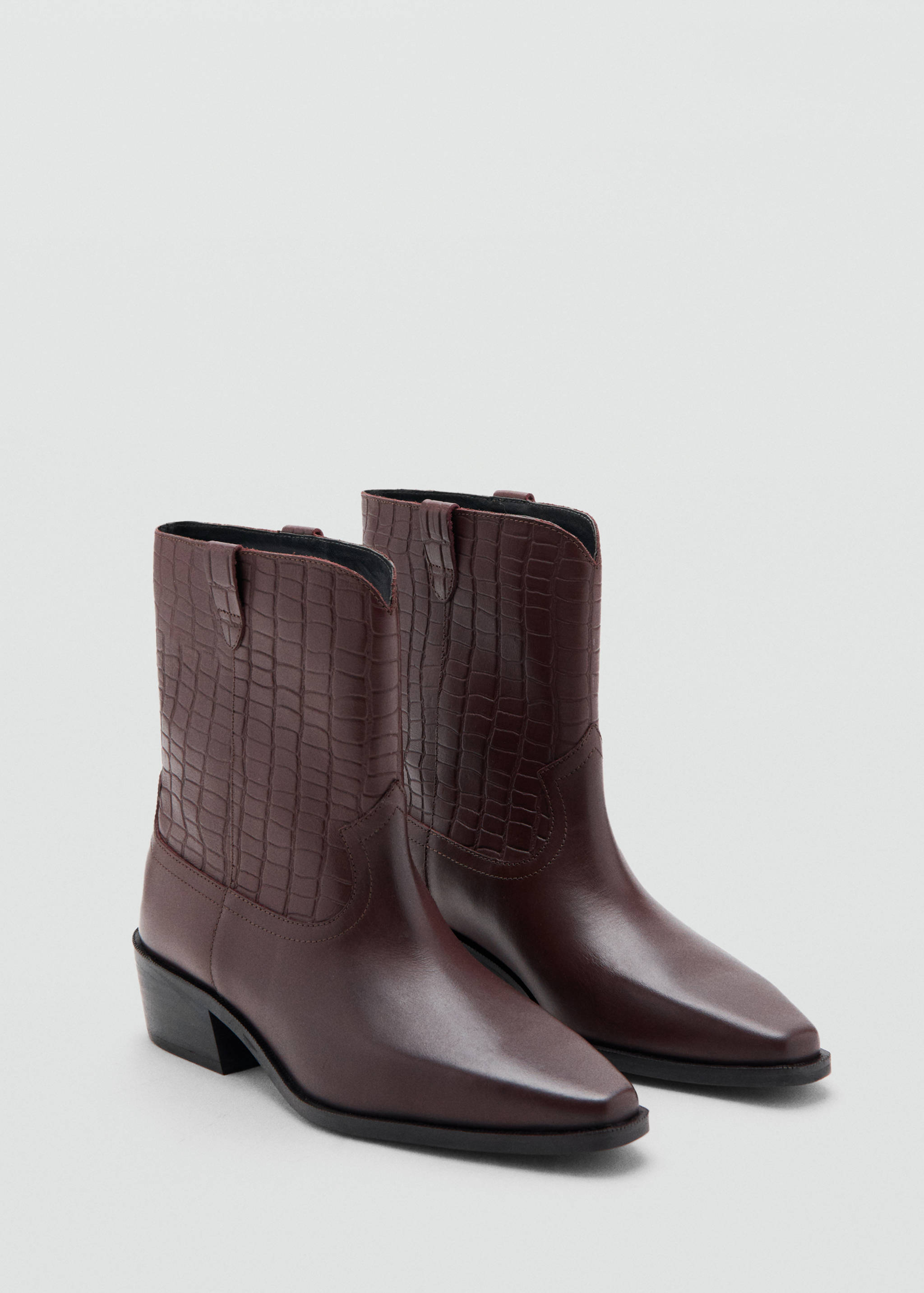 Dark burgundy cowboy ankle boots with textured shafts and pointed toes.