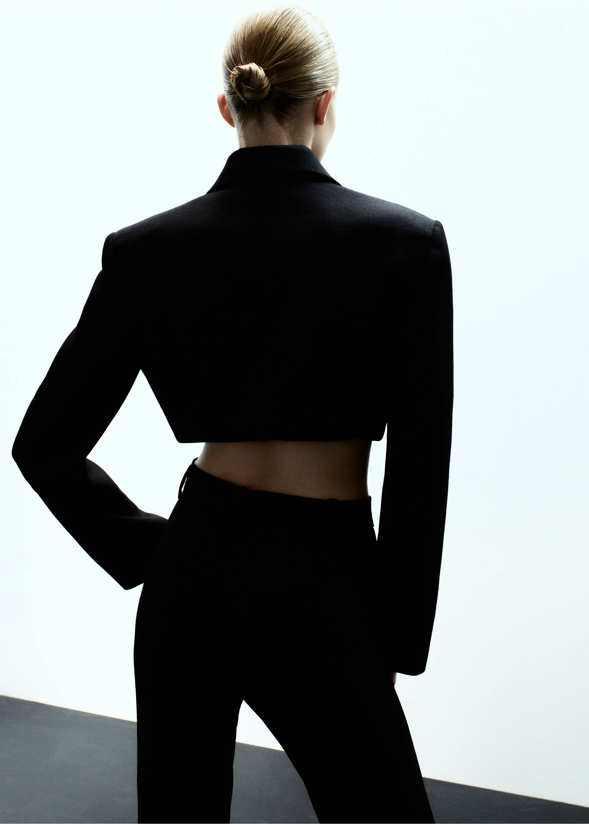 Back view of a black cropped blazer with a lapel collar., Black. Ref: 17079120-00.