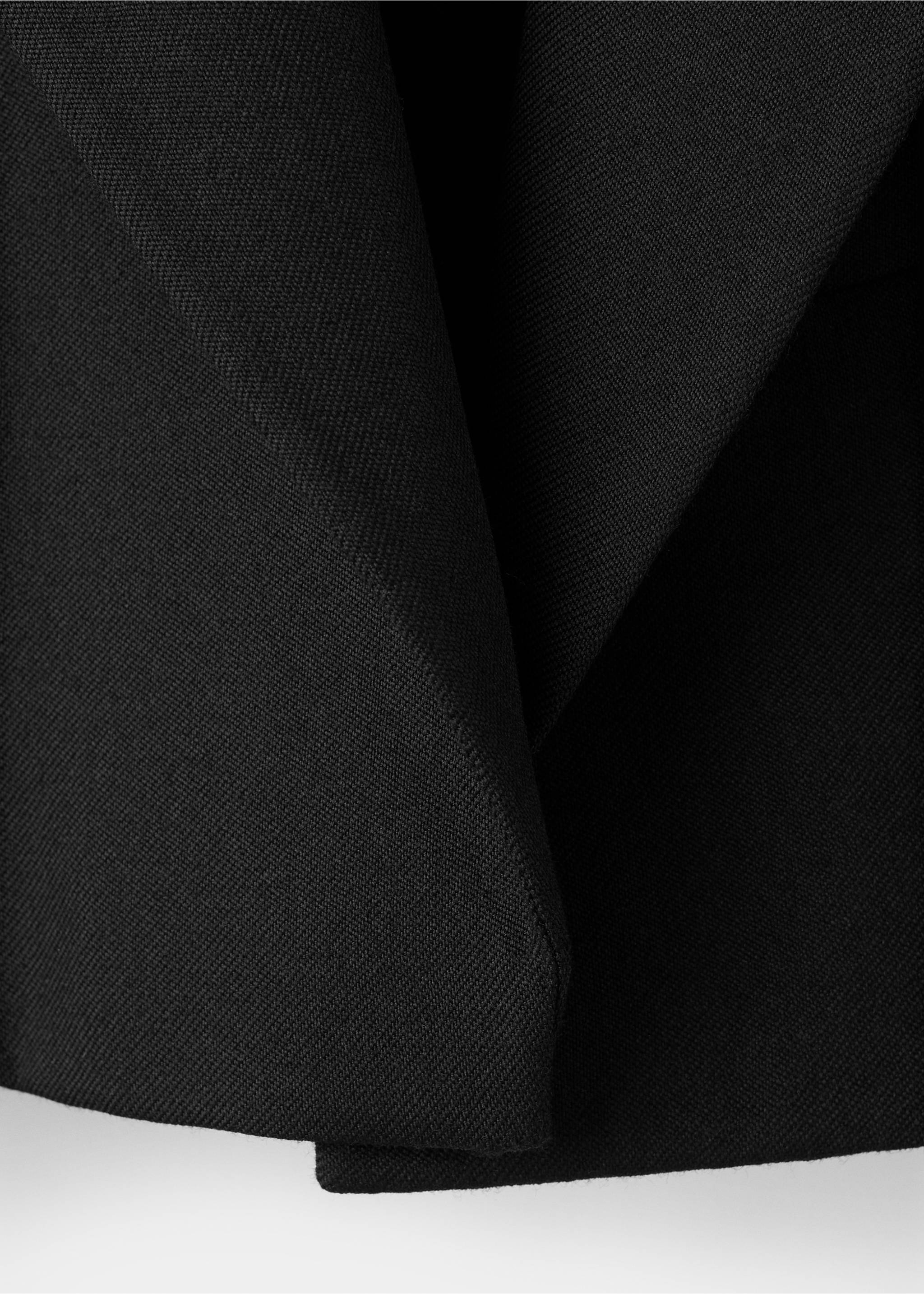 Close-up of the black fabric and lapel detail on a blazer., Black. Ref: 17079120-00.