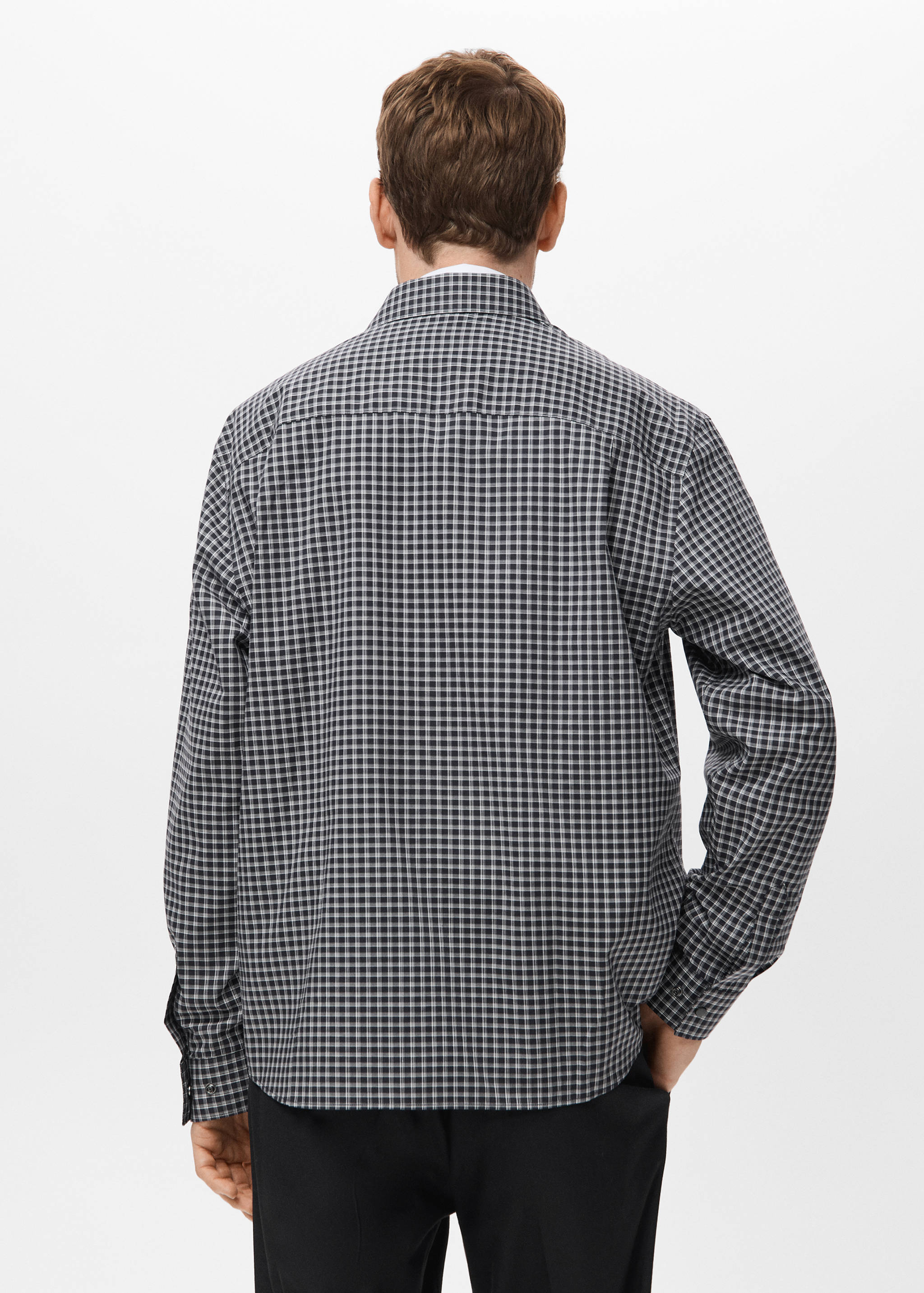Back view of a black and white checked long-sleeved shirt with a classic collar.