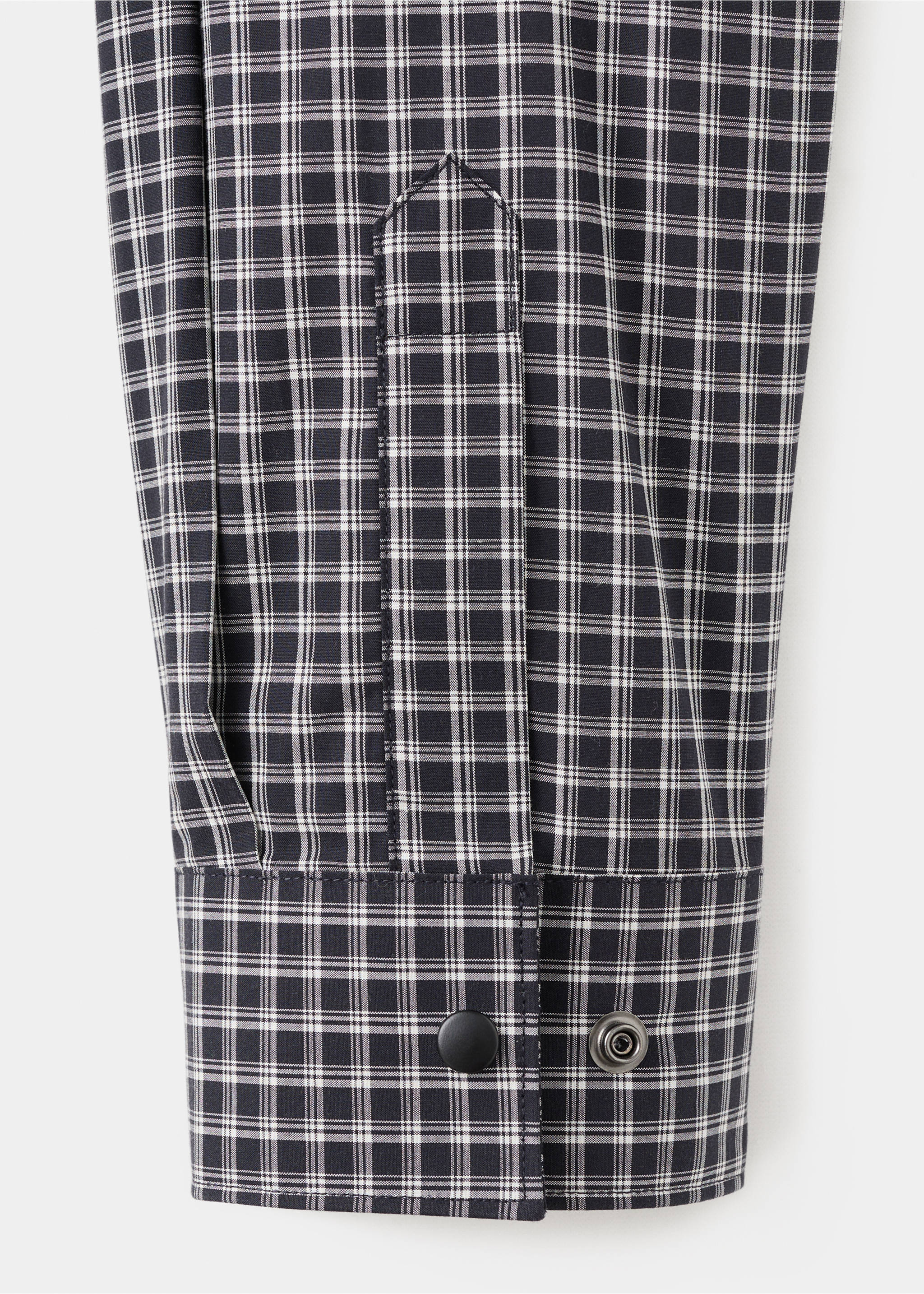 Close-up of a black and white checkered shirt cuff with snap buttons., Black. Ref: 17079207-00.