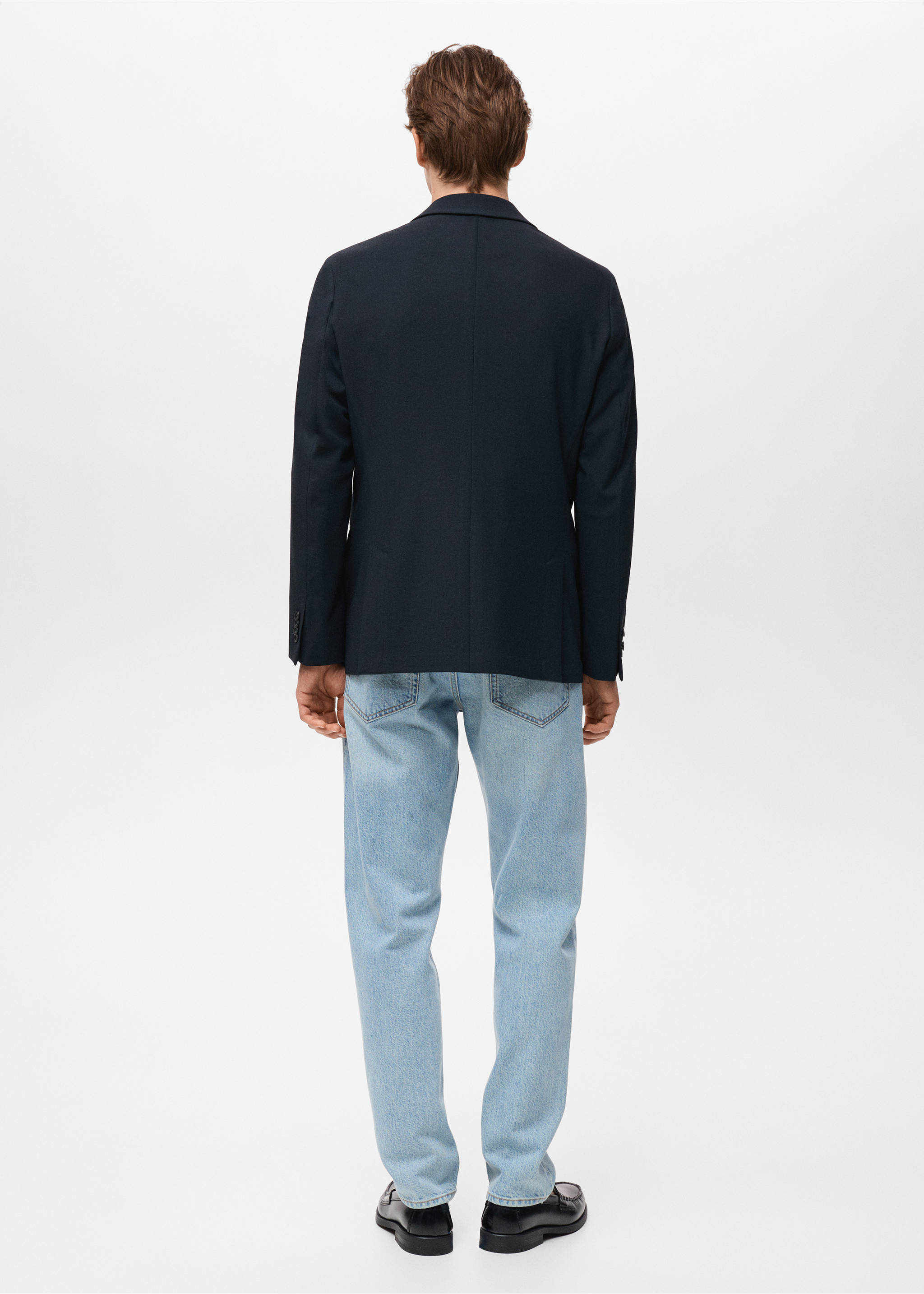 Dark navy blue blazer shown from the back, worn with light blue jeans., Navy. Ref: 17081184-00.