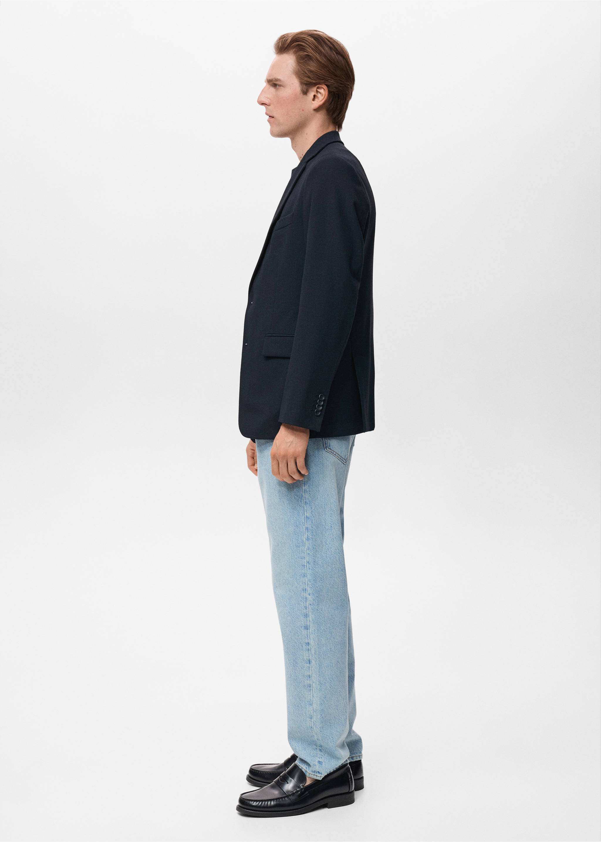 Navy blue blazer with notched lapels and front flap pockets, in profile view., Navy. Ref: 17081184-00.