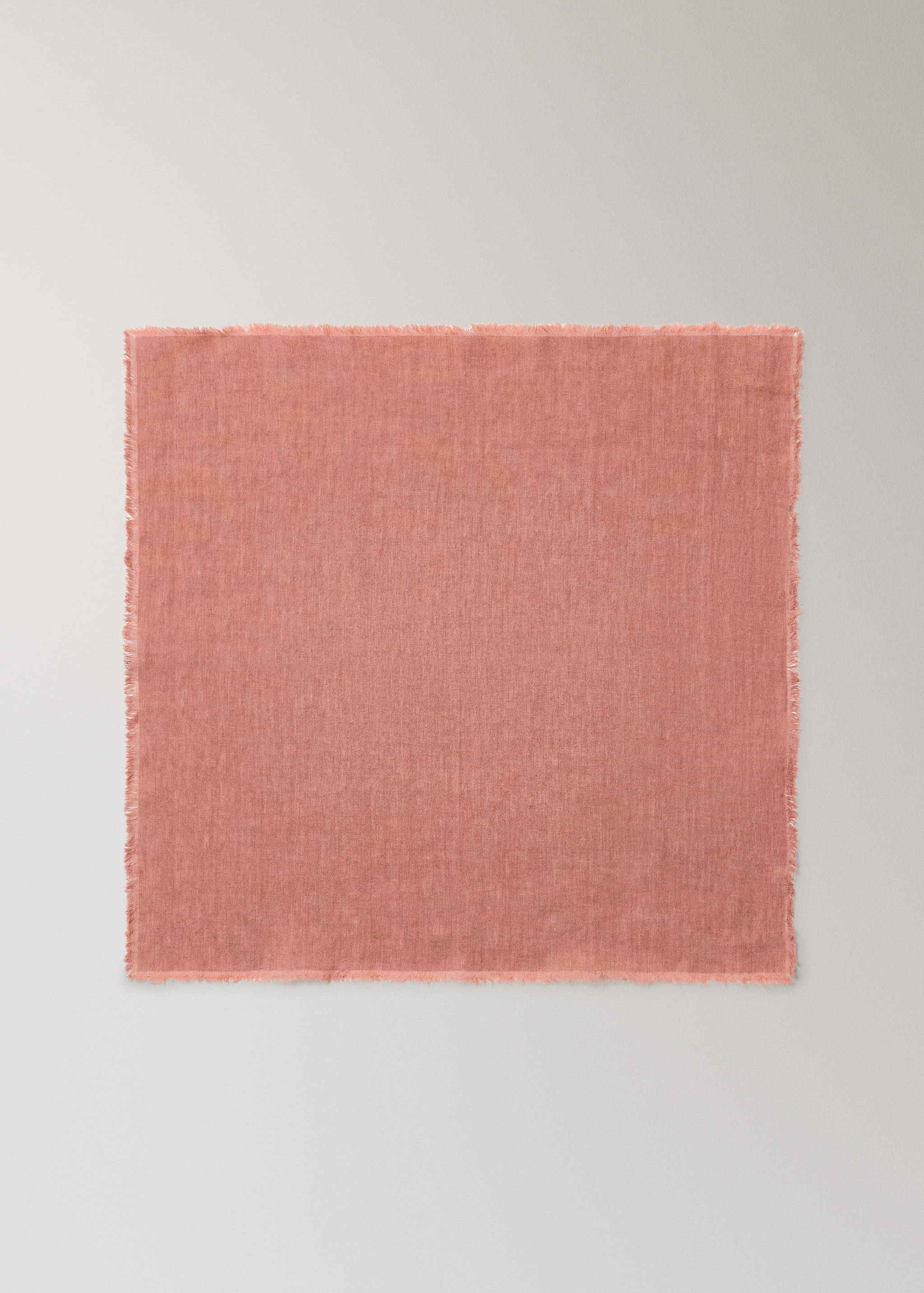 Pink napkin with frayed edges.