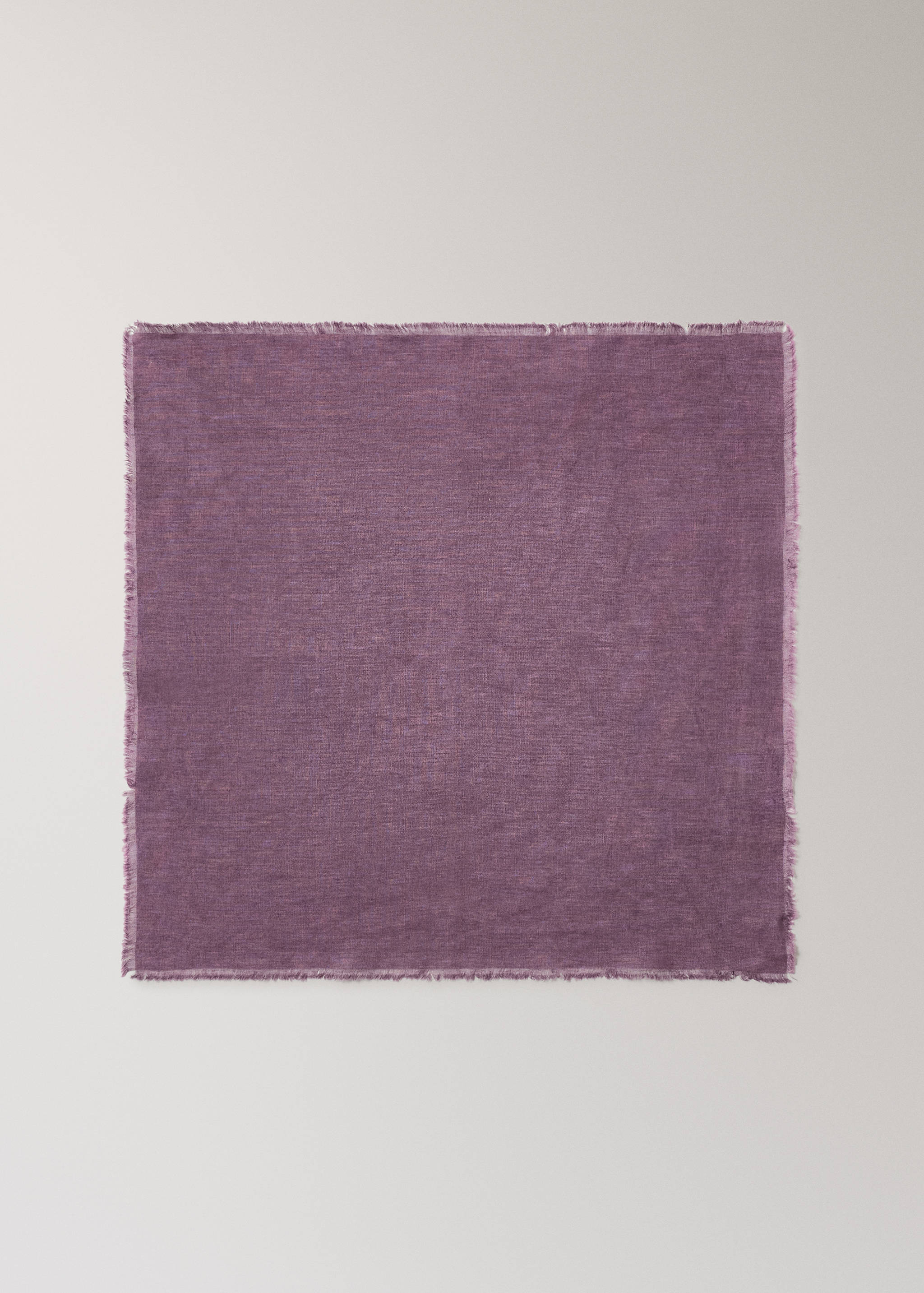 Square purple napkin with frayed edges.