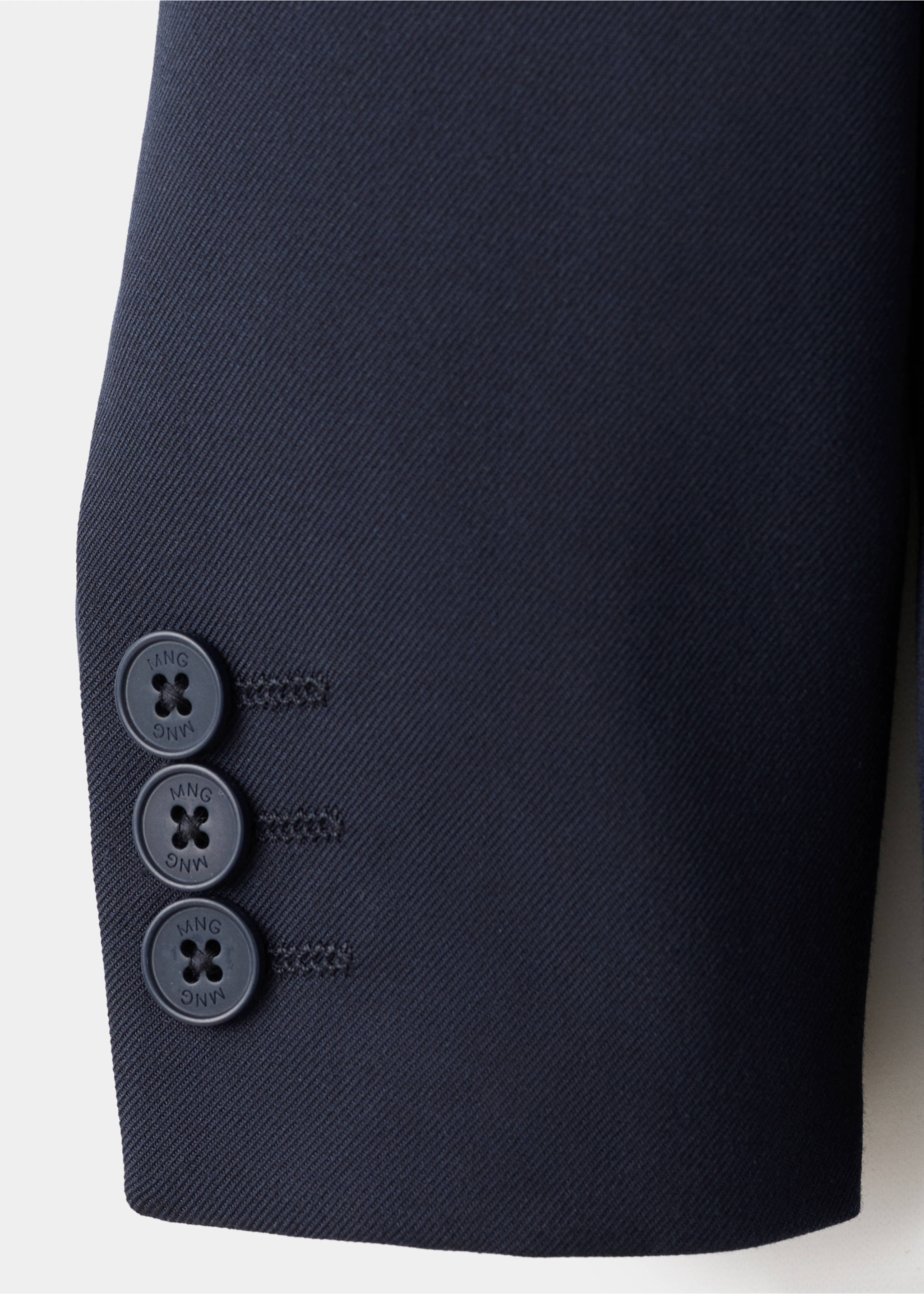 Close-up of a navy kids' jacket sleeve cuff showing the twill fabric texture and three buttons., Dark Navy. Ref: 17087759-00.