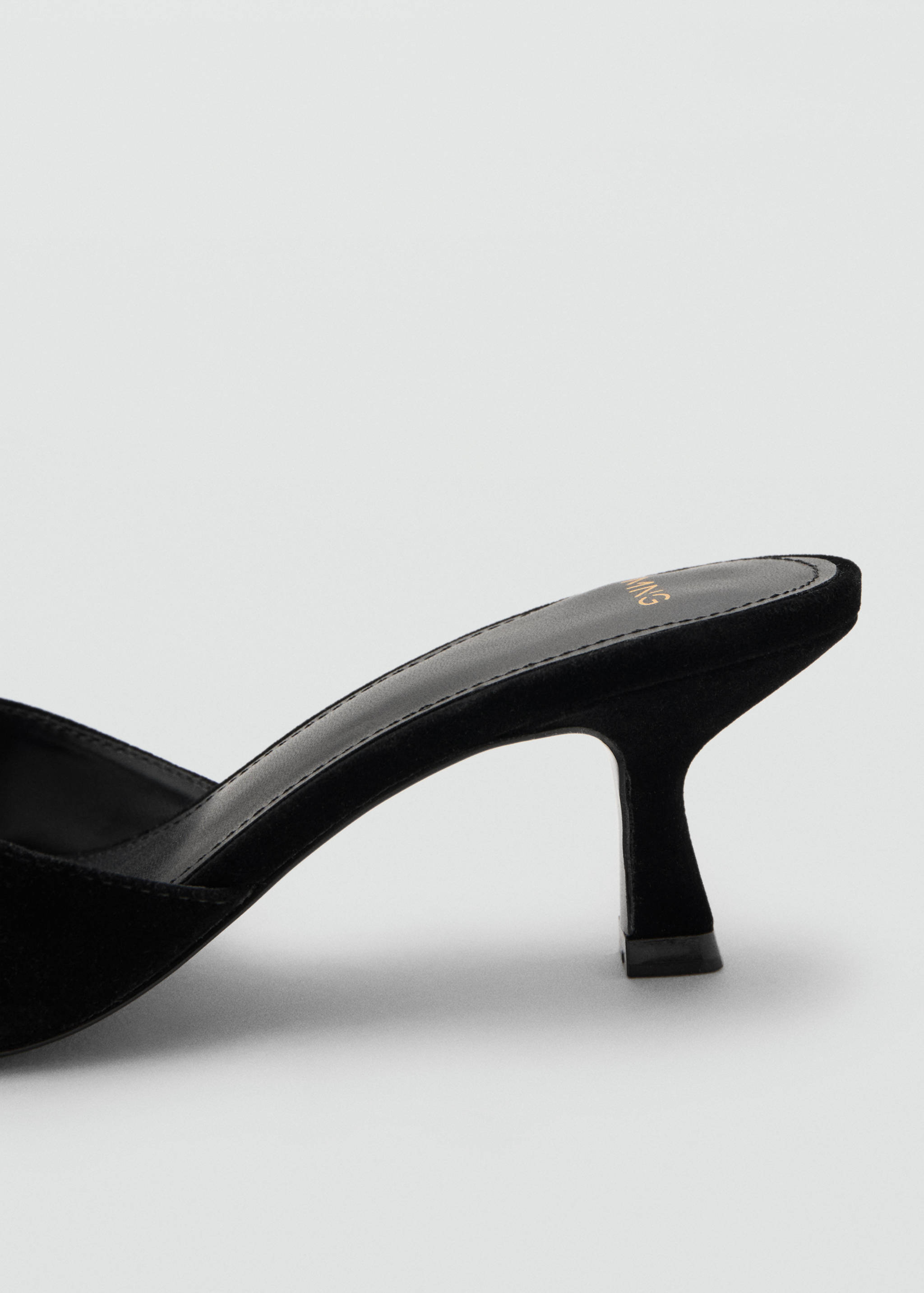 Close-up of a black shoe showing the heel detail.