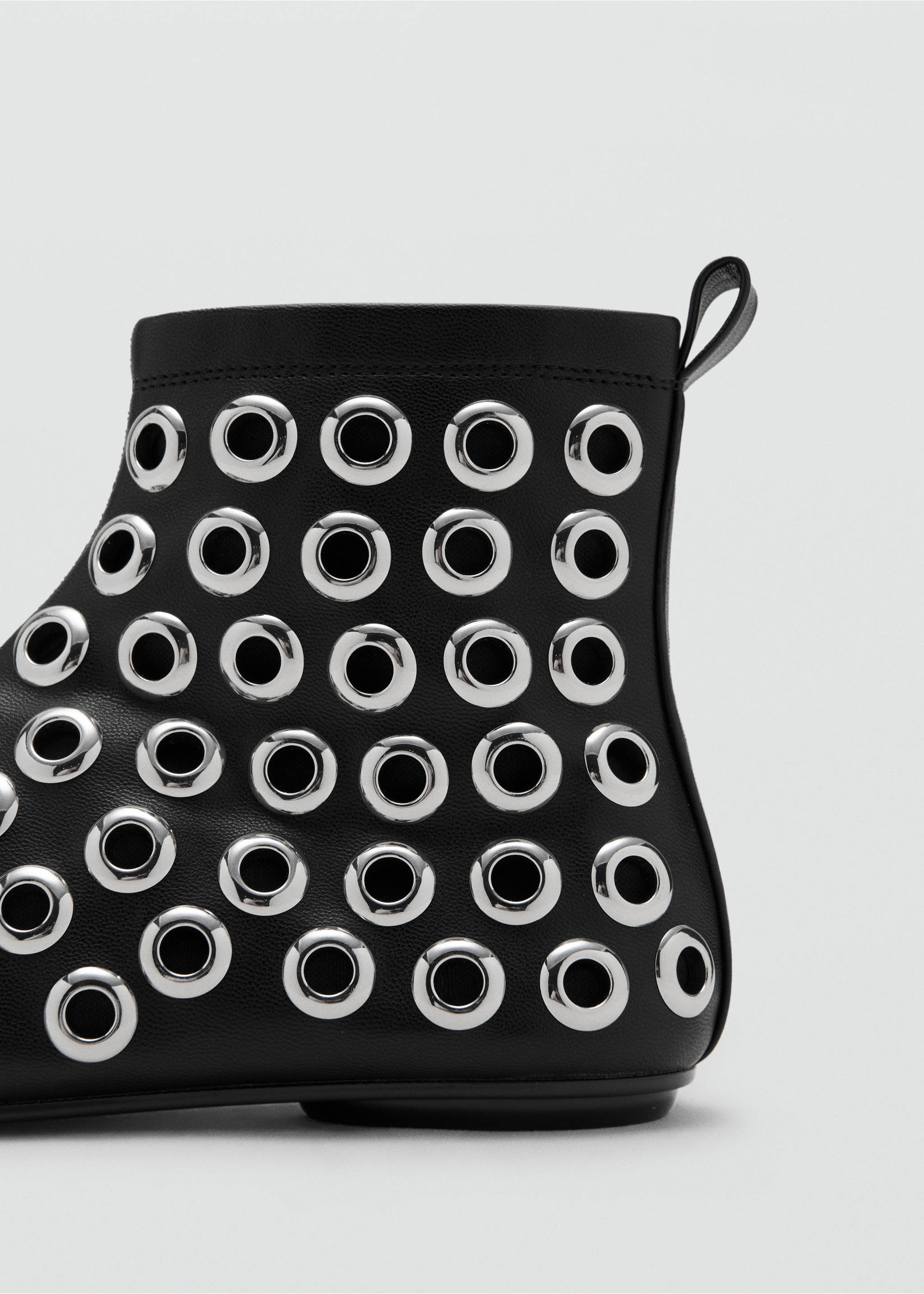 Close-up of a black ankle boot featuring polished silver-tone metal eyelets., Black. Ref: 17088633-00.