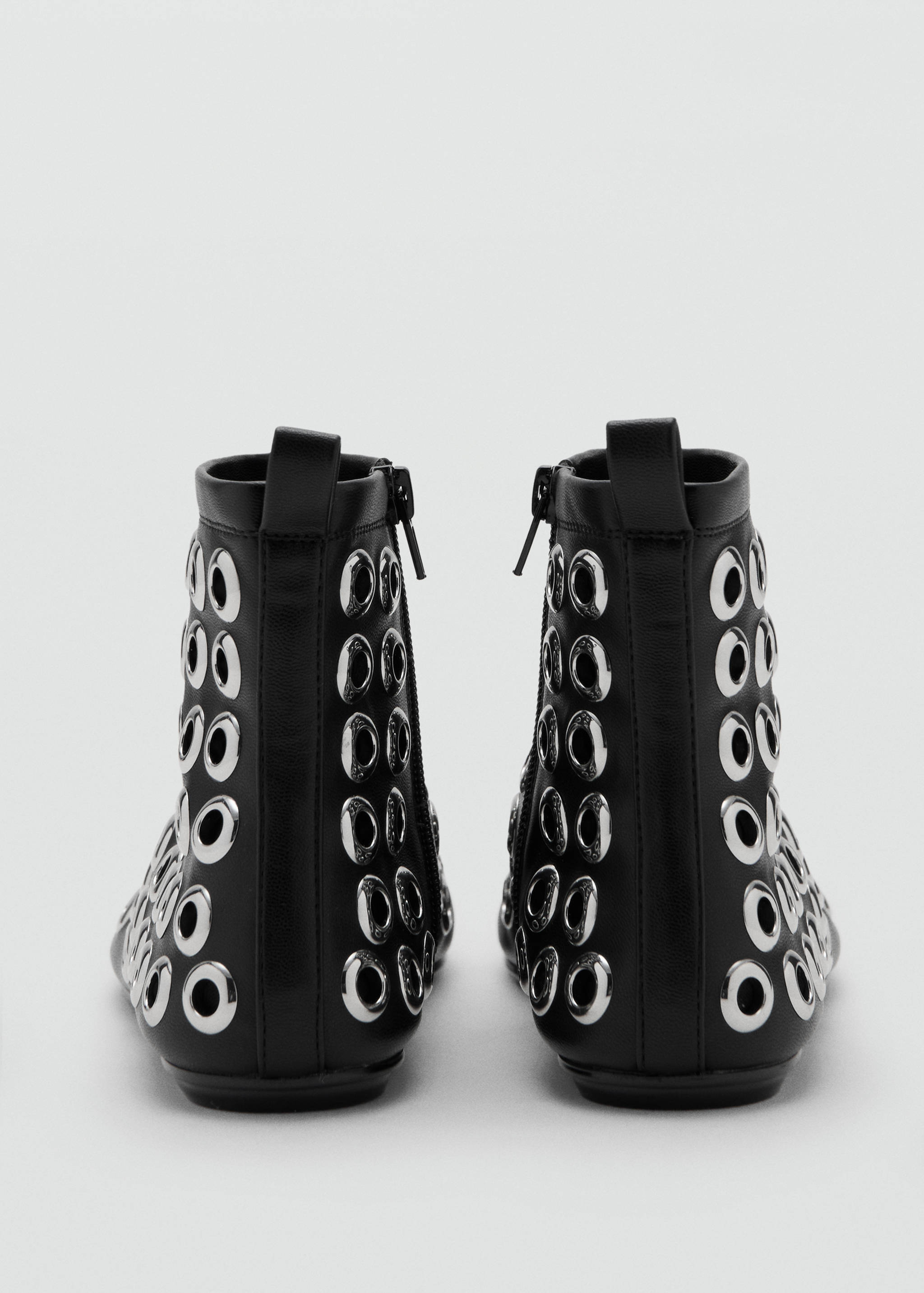 Black ankle boots with back zip and metallic silver eyelet details.