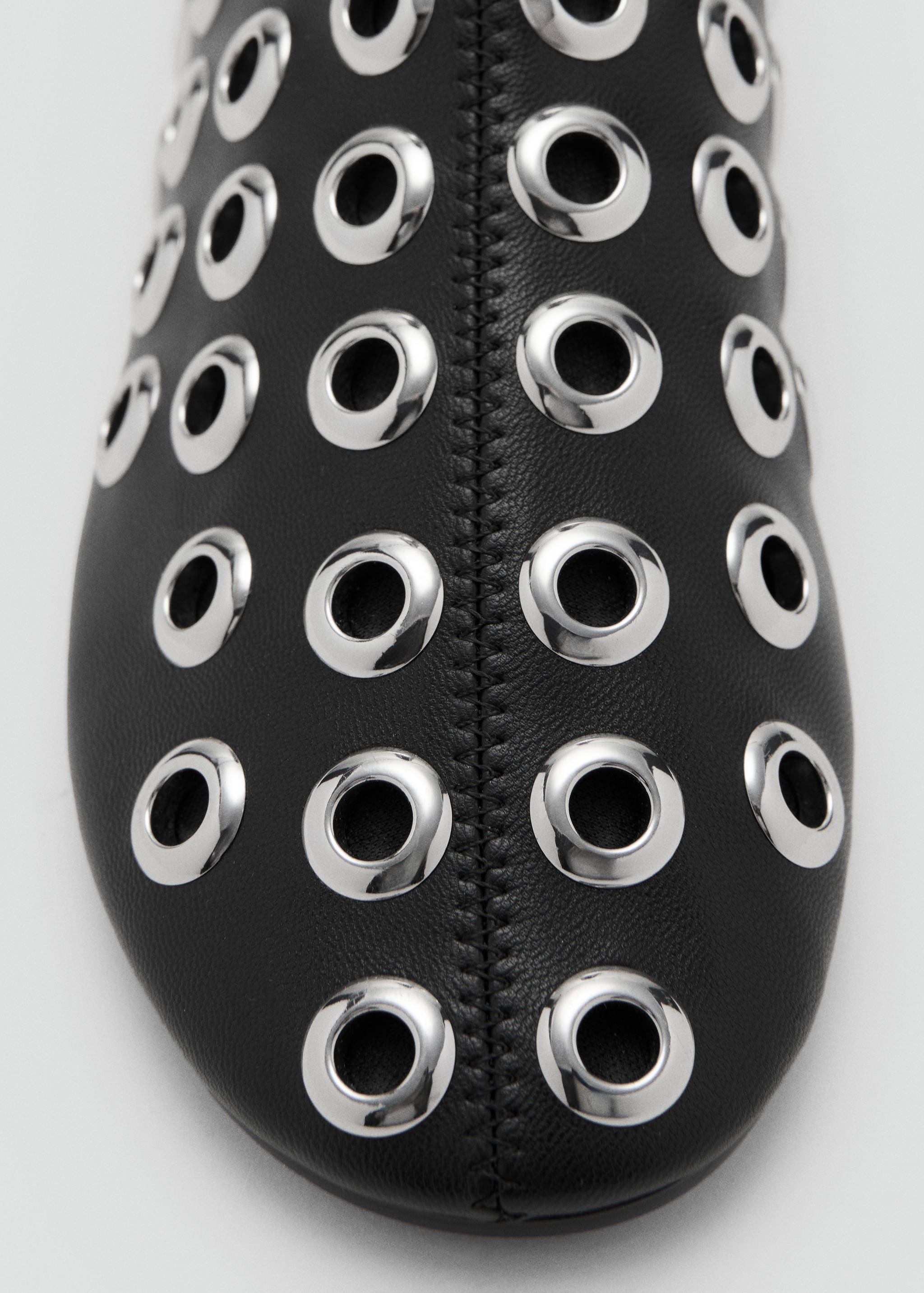 Black ankle boot detail with silver eyelets