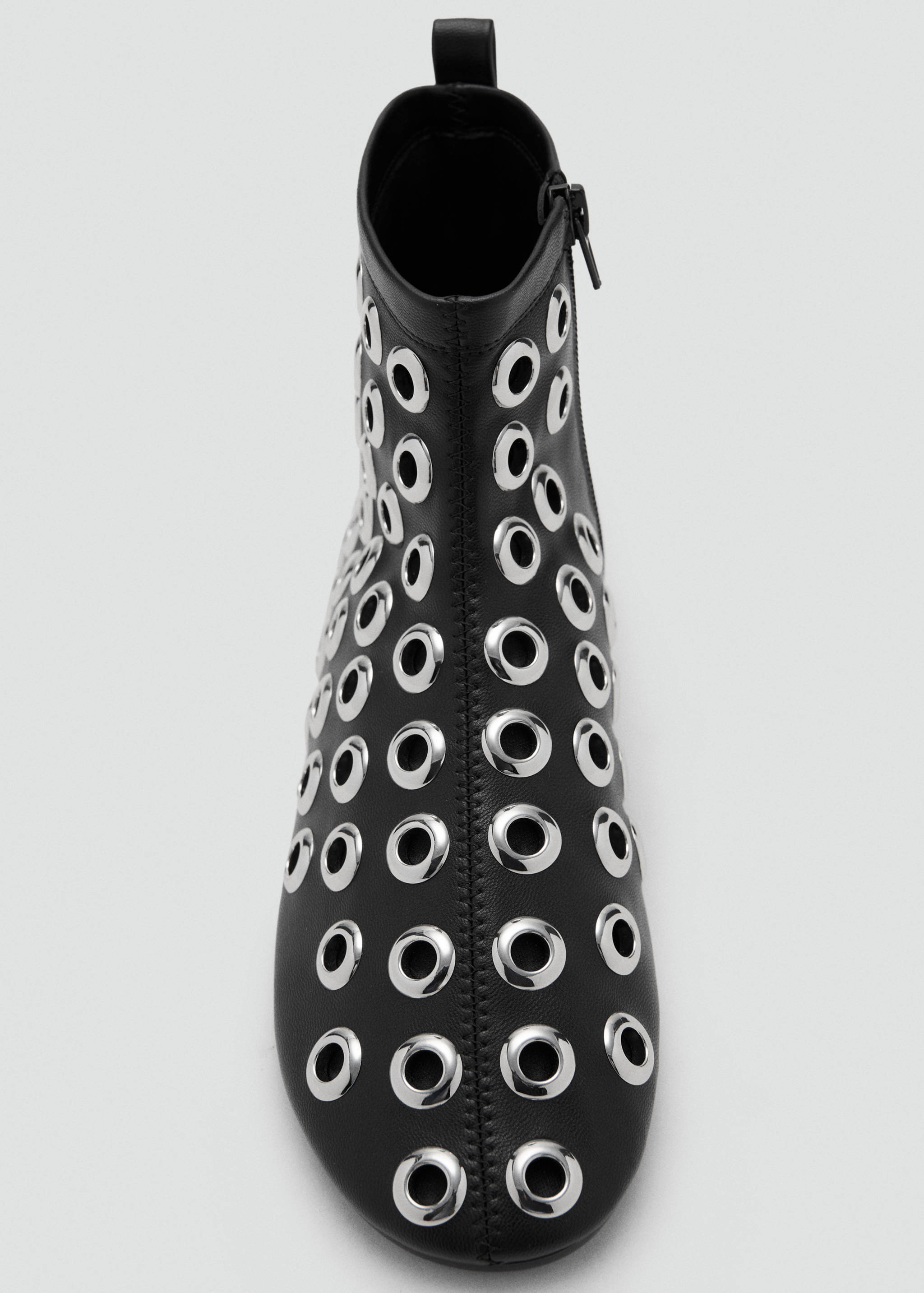 Black ankle boot embellished with silver-toned metal eyelets.