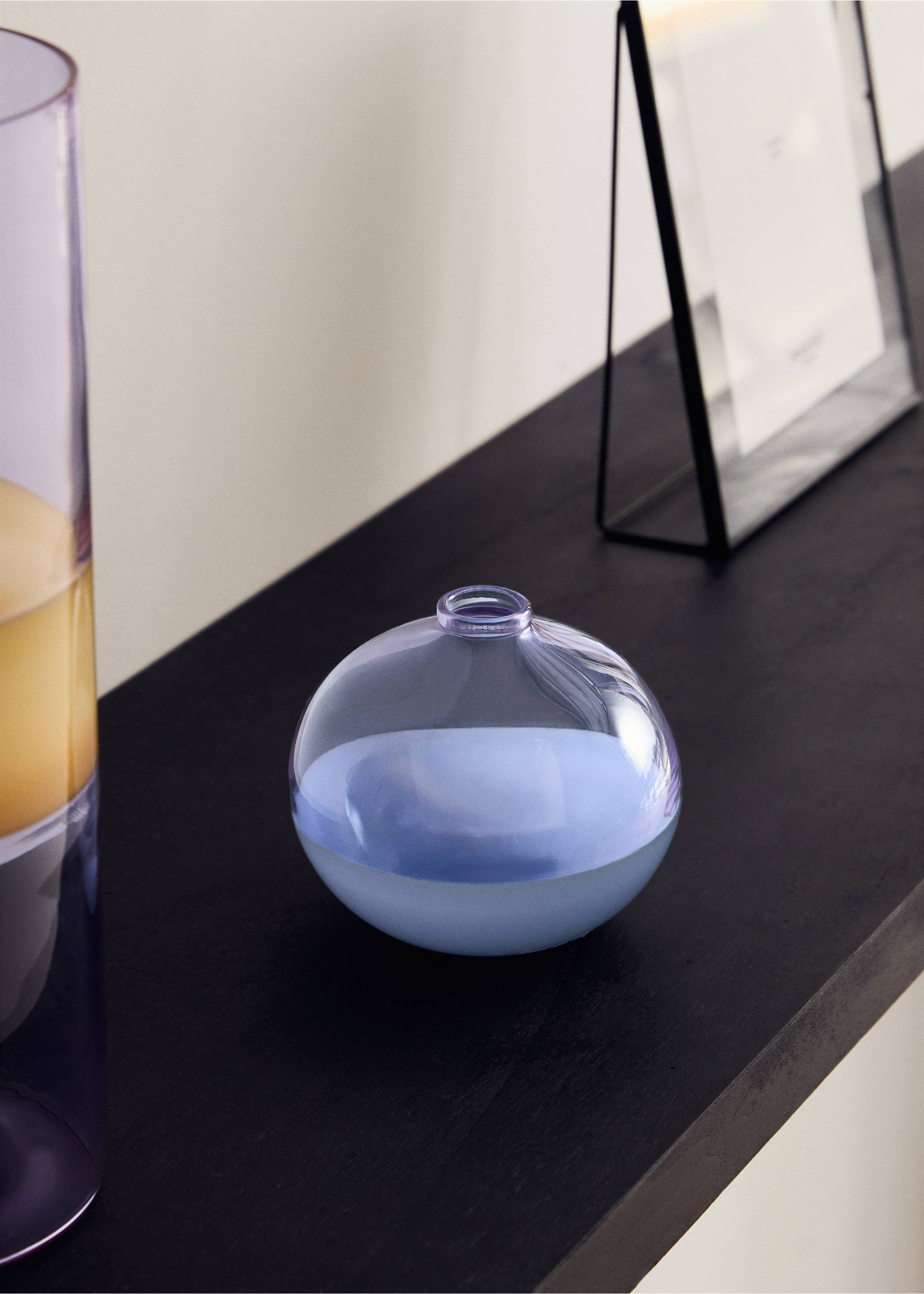 Spherical glass vase in light blue and lilac on a dark surface., Lilac. Ref: 17093824-00.