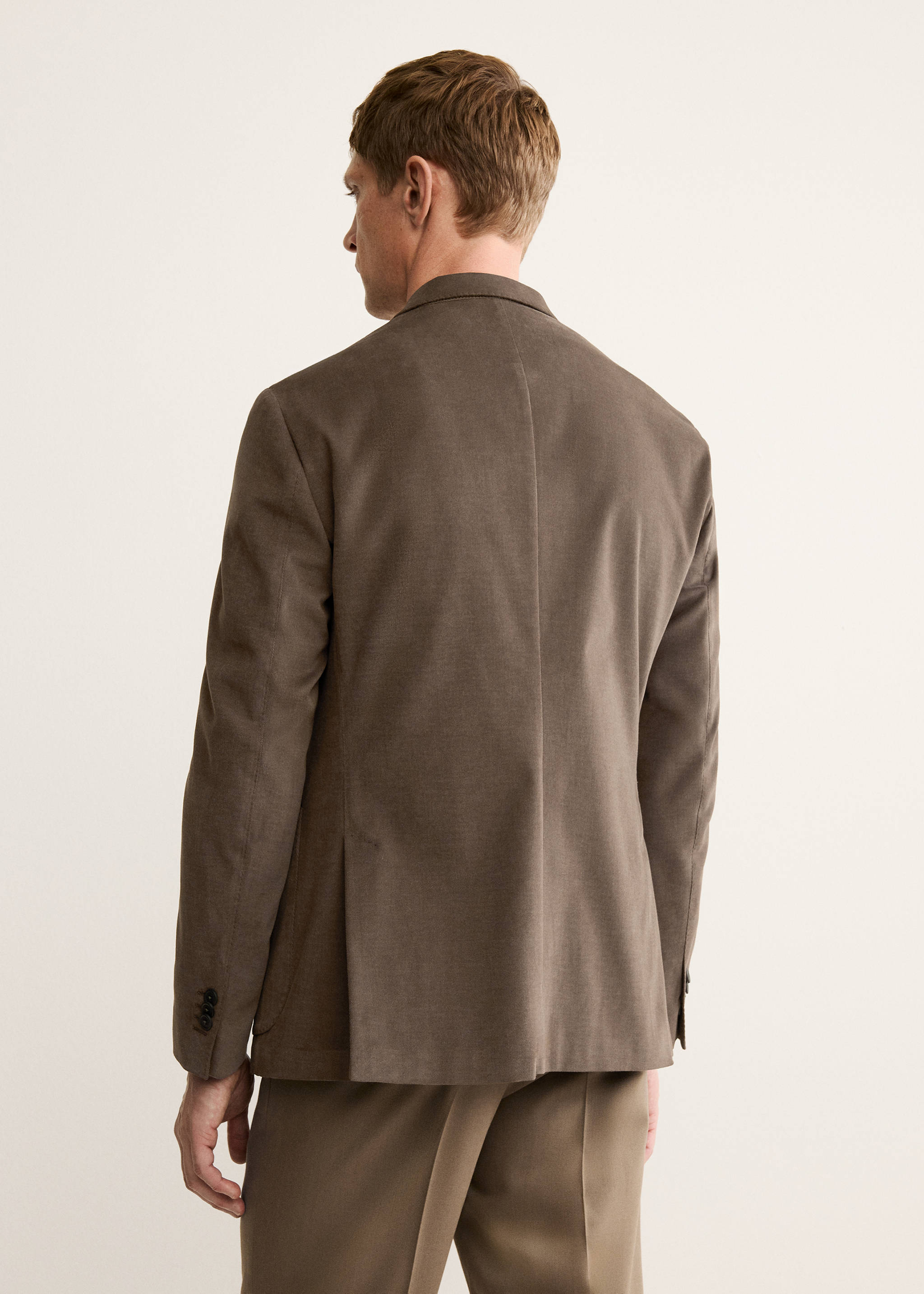 Brown blazer seen from the back.