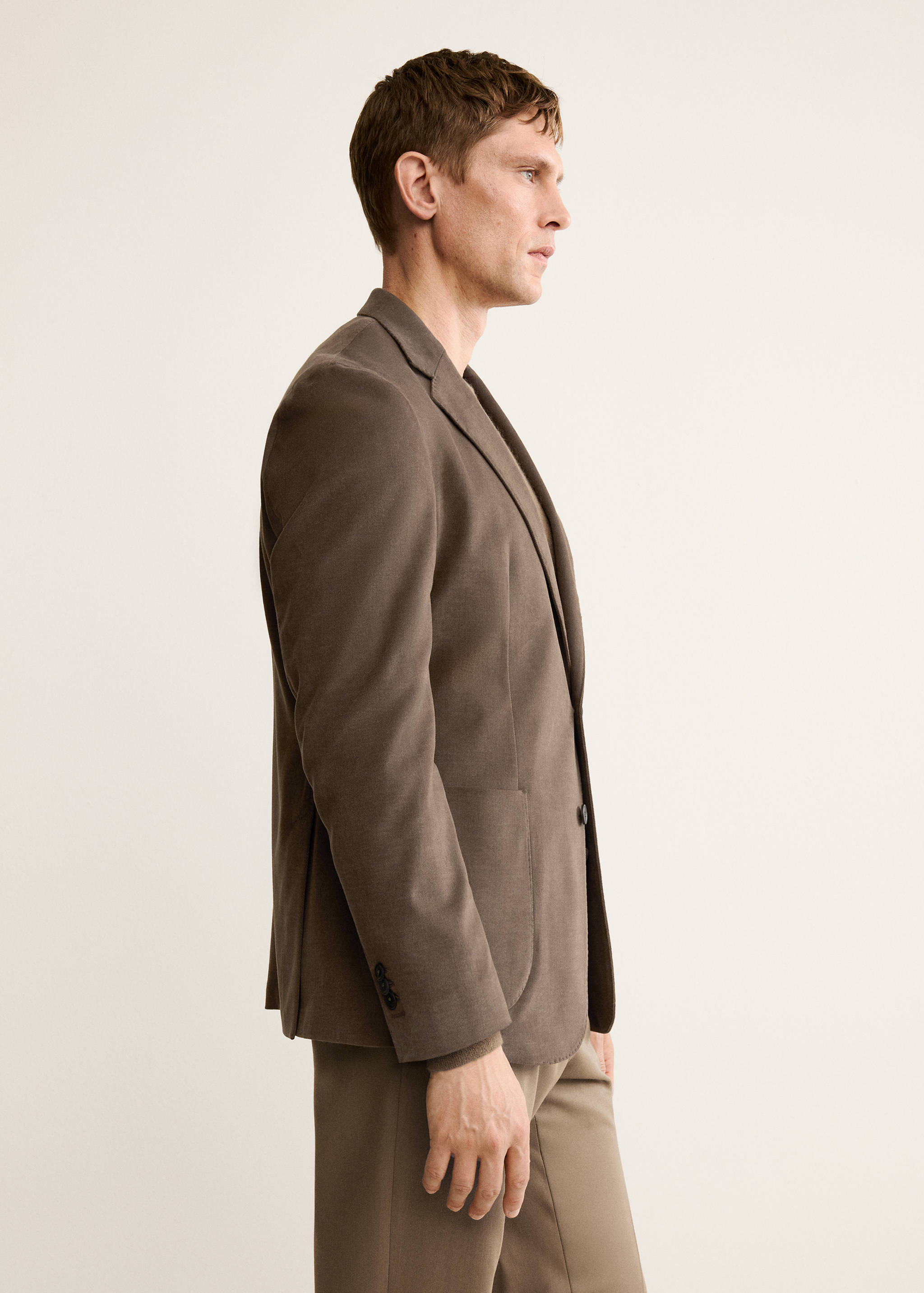 Brown blazer with notched lapel and single-button closure.
