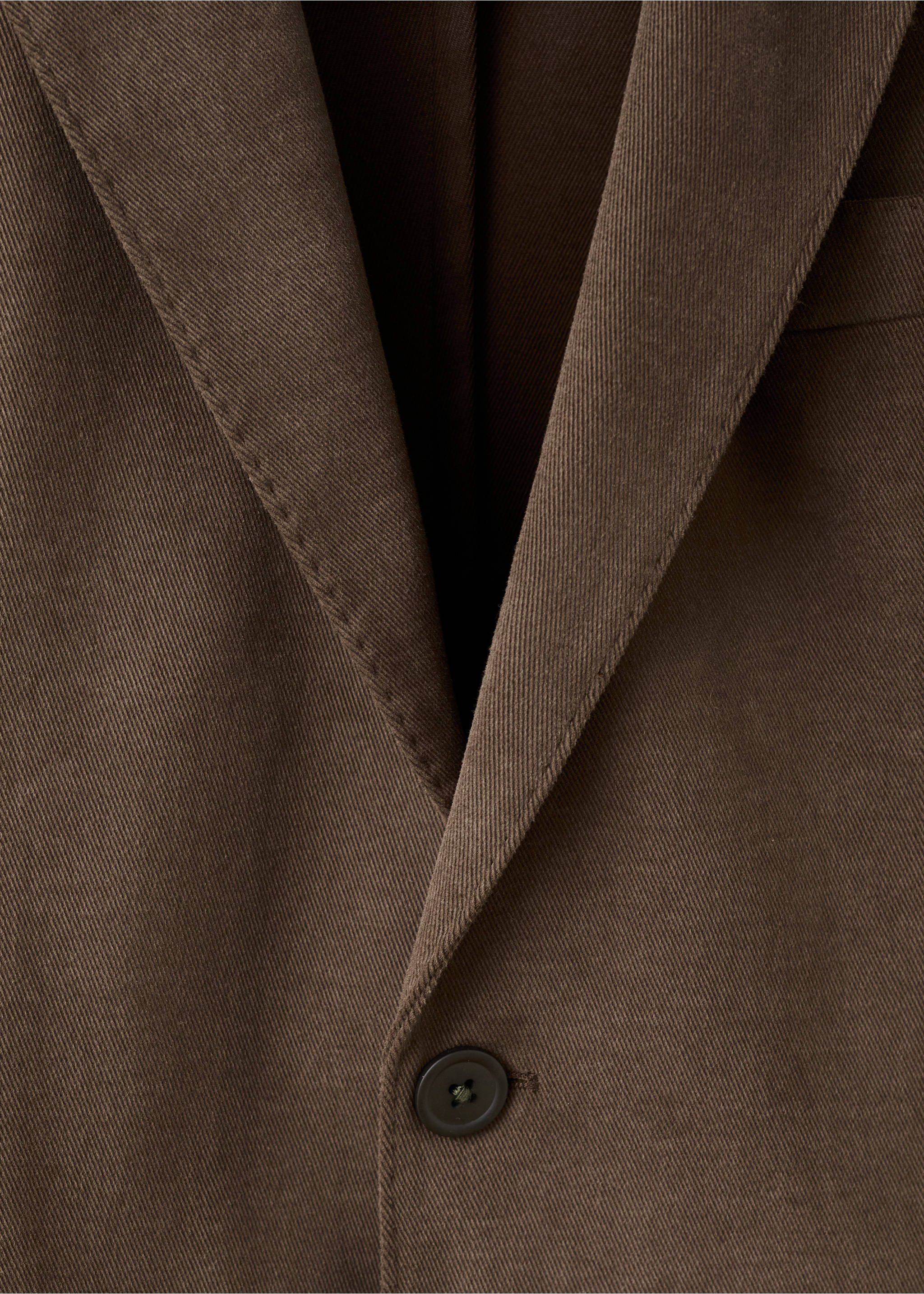 Brown blazer detail featuring notched lapels and a single-button closure., Caramel. Ref: 17098268-00.