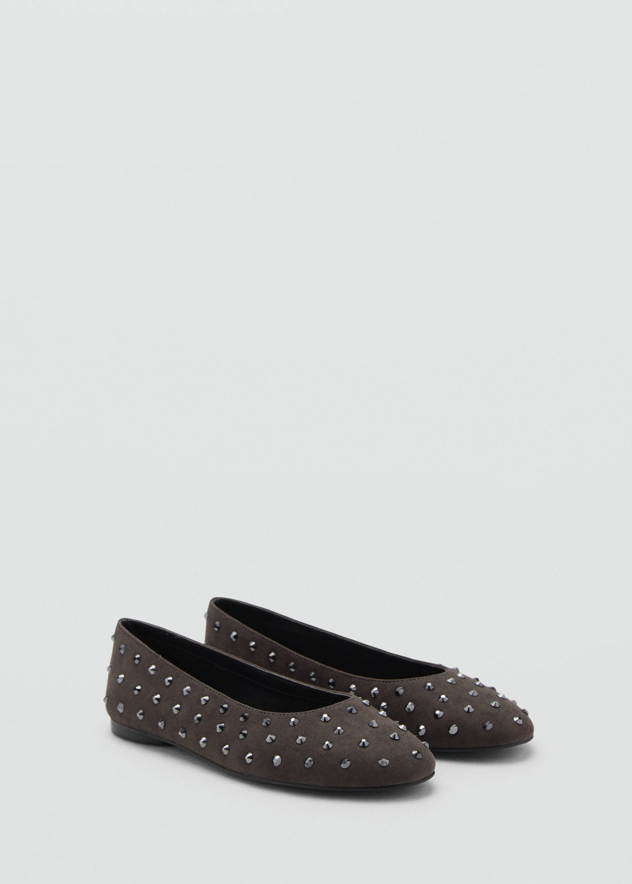 Dark brown flat shoes with rounded toes and all-over metallic stud embellishments.