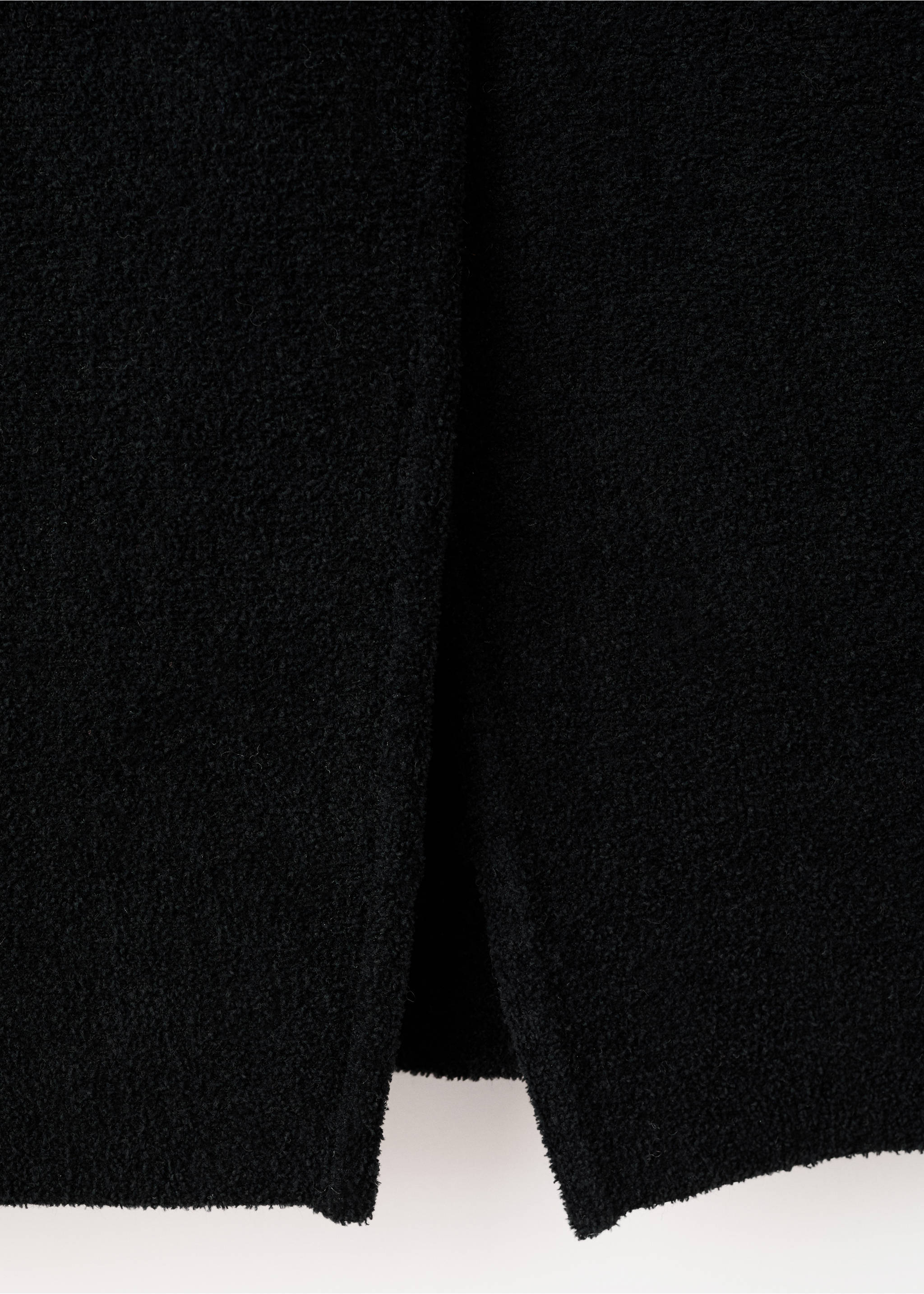 Black jacket fabric detail showing textured material and slit., Black. Ref: 17099103-00.